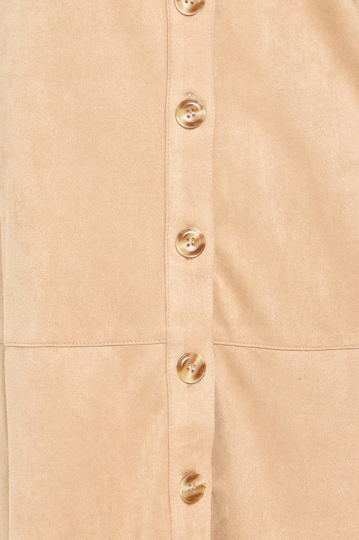 Woman wearing a long sleeve beige suede mini dress with buttons along the front, collar, and self tie matching belt | Flying Tomato