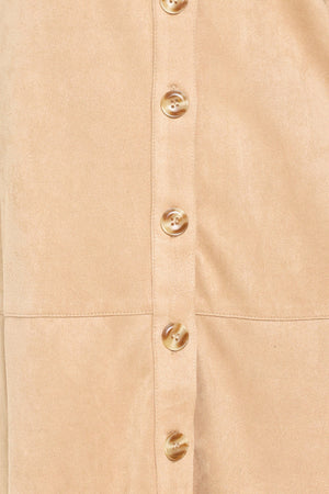 Woman wearing a long sleeve beige suede mini dress with buttons along the front, collar, and self tie matching belt | Flying Tomato