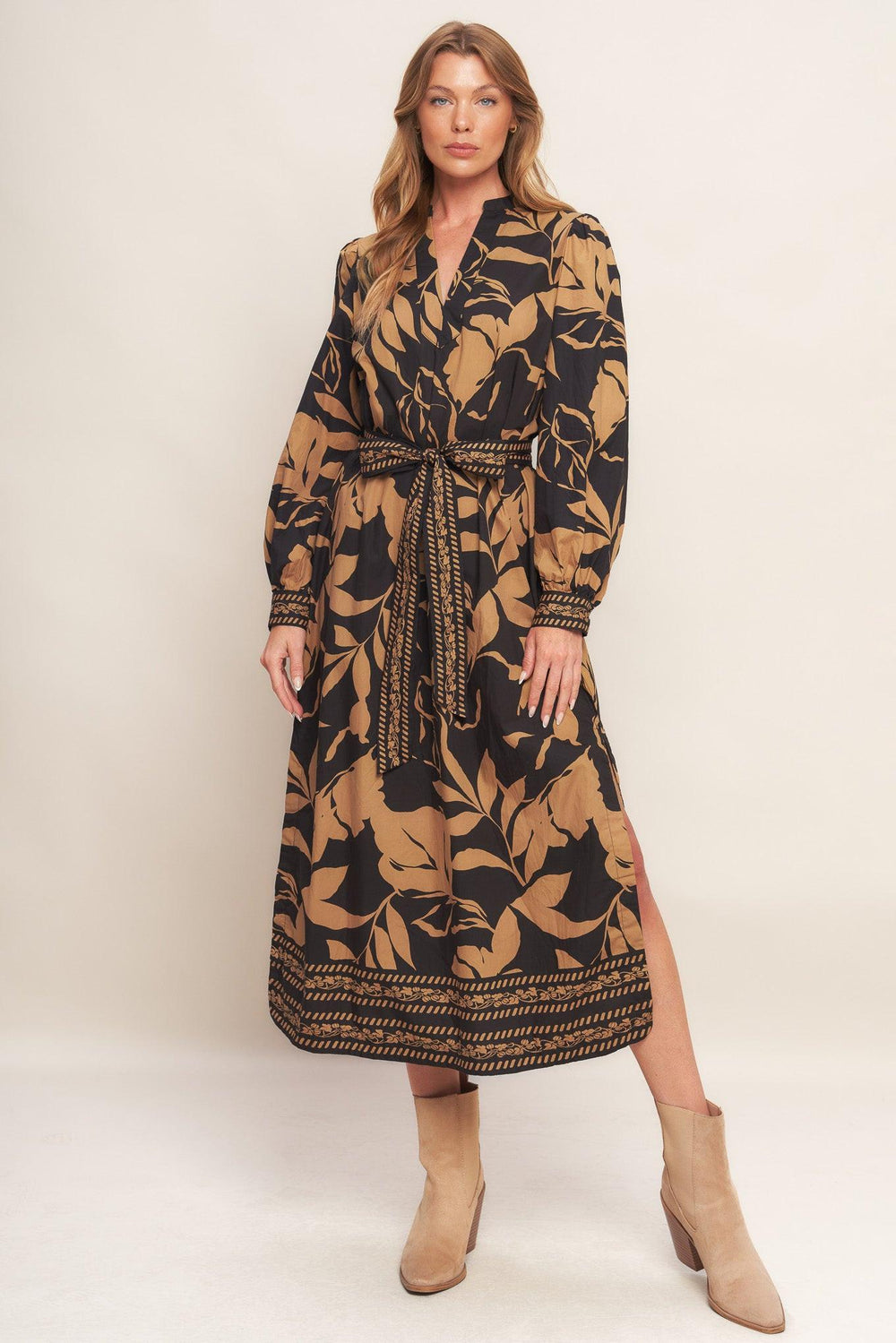 A printed woven midi dress featuring high neckline with V front, short puff sleeve and self sash tie
