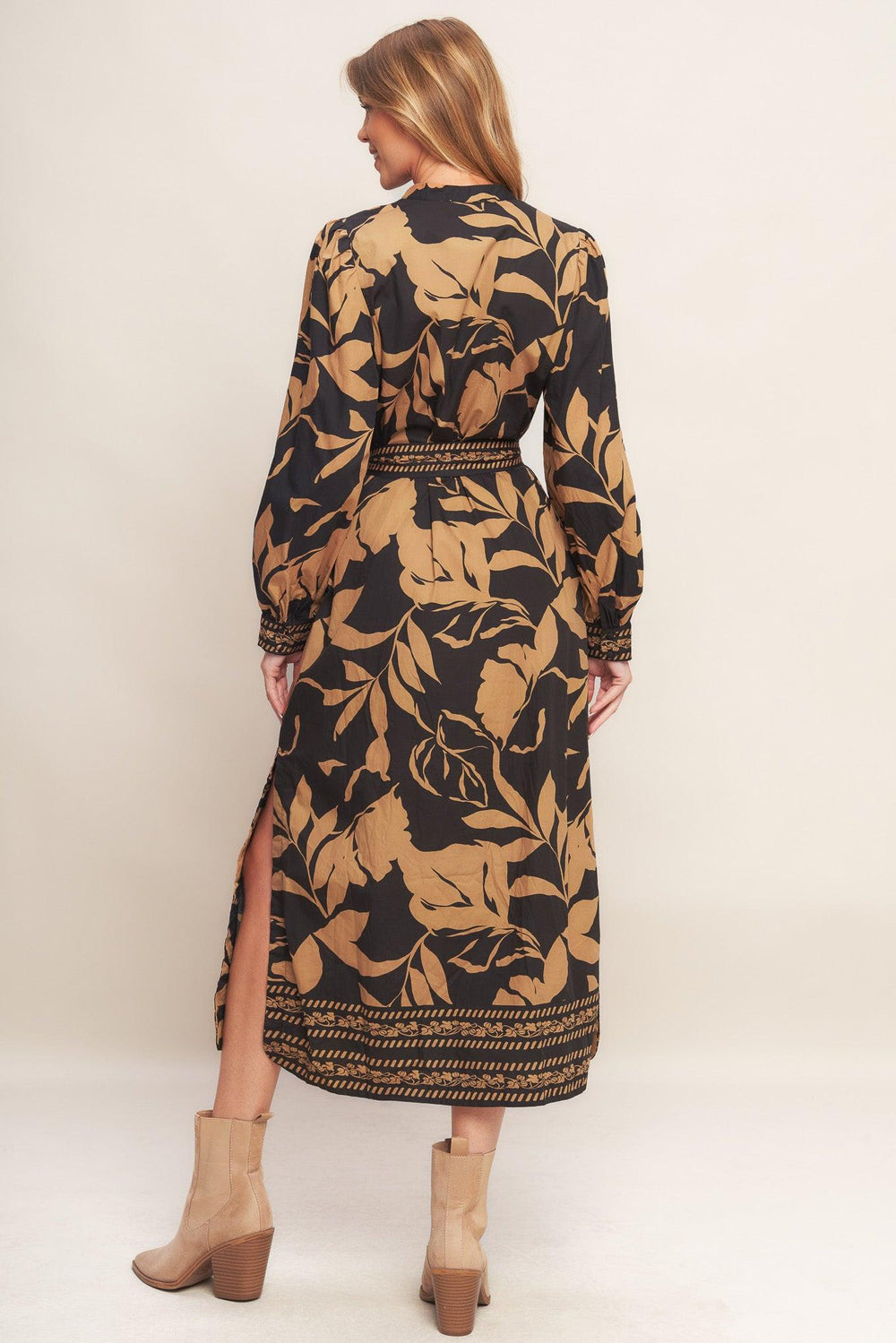A printed woven midi dress featuring high neckline with V front, short puff sleeve and self sash tie
