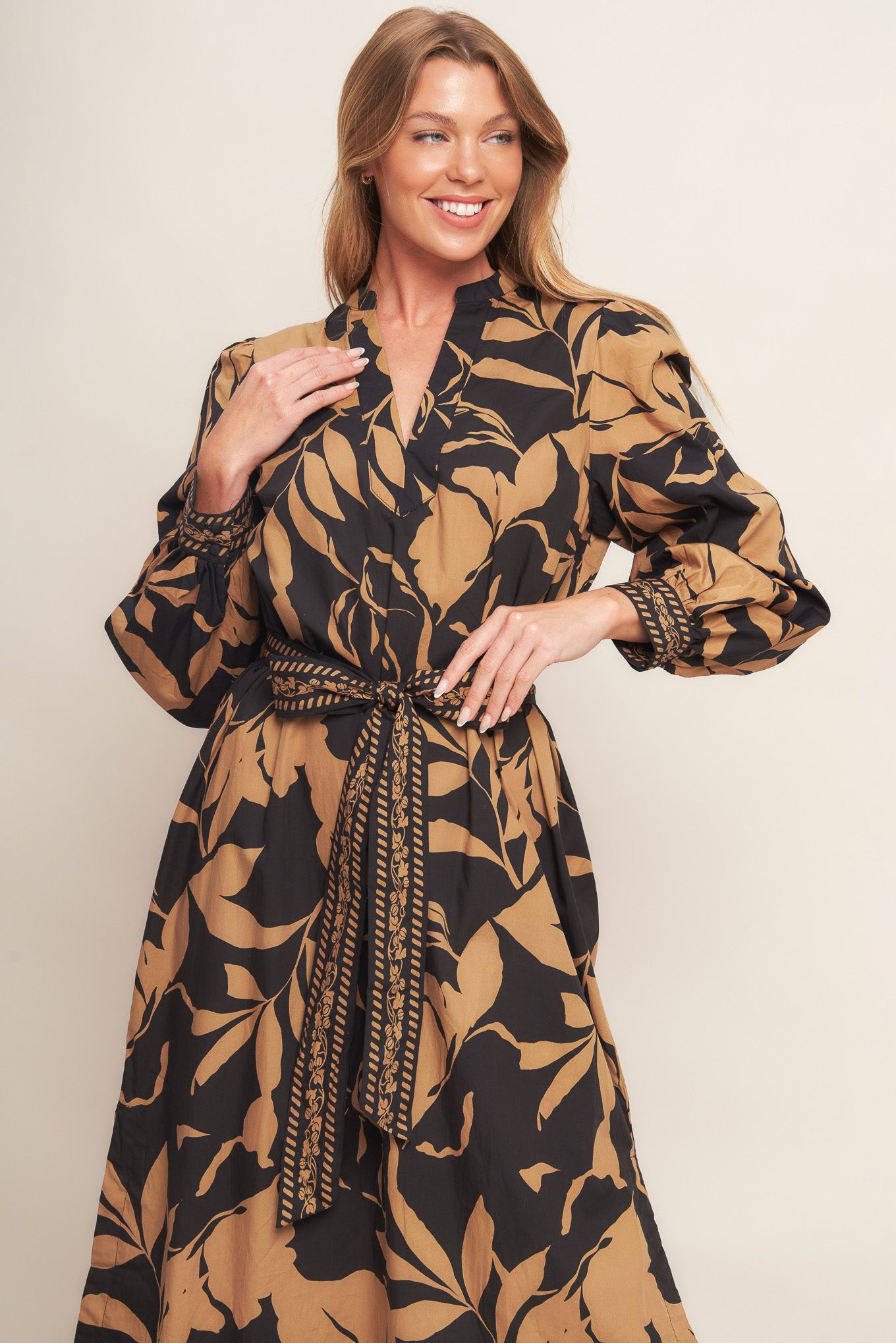 A printed woven midi dress featuring high neckline with V front, short puff sleeve and self sash tie