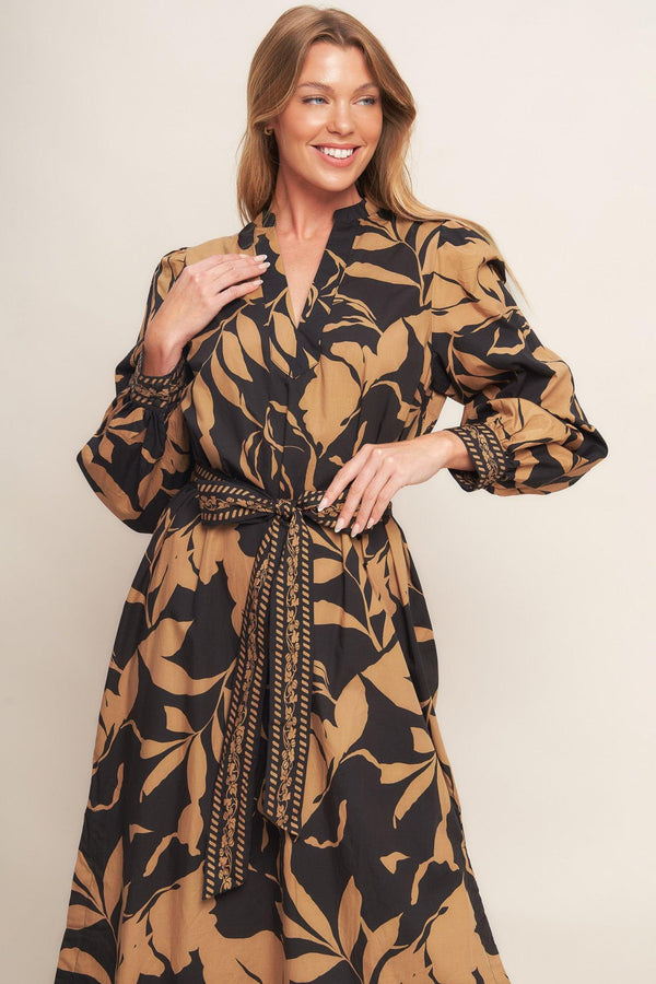 A printed woven midi dress featuring high neckline with V front, short puff sleeve and self sash tie