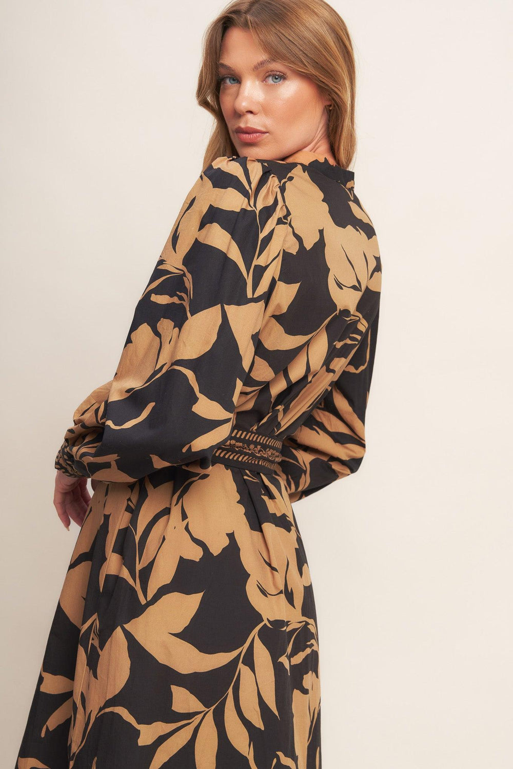 A printed woven midi dress featuring high neckline with V front, short puff sleeve and self sash tie
