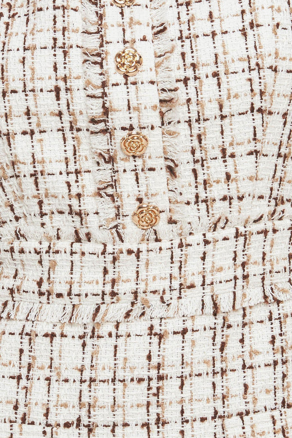 A tweed mini dress featuring straight neckline, sleeveless, front button detail and back zipper closure