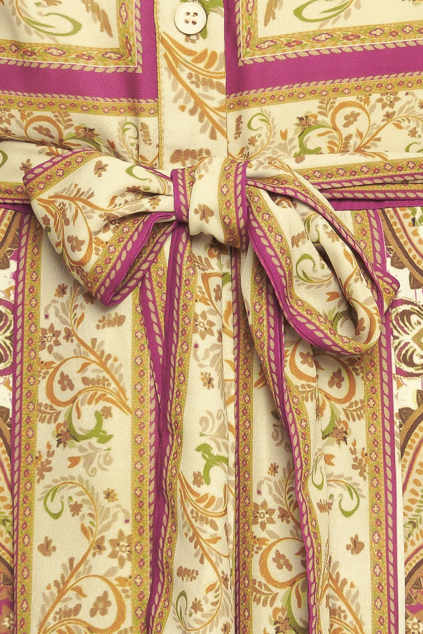 A printed woven maxi dress featuring collar, long sleeve with cuff, front button down, self sash tie and ruffled hemline
