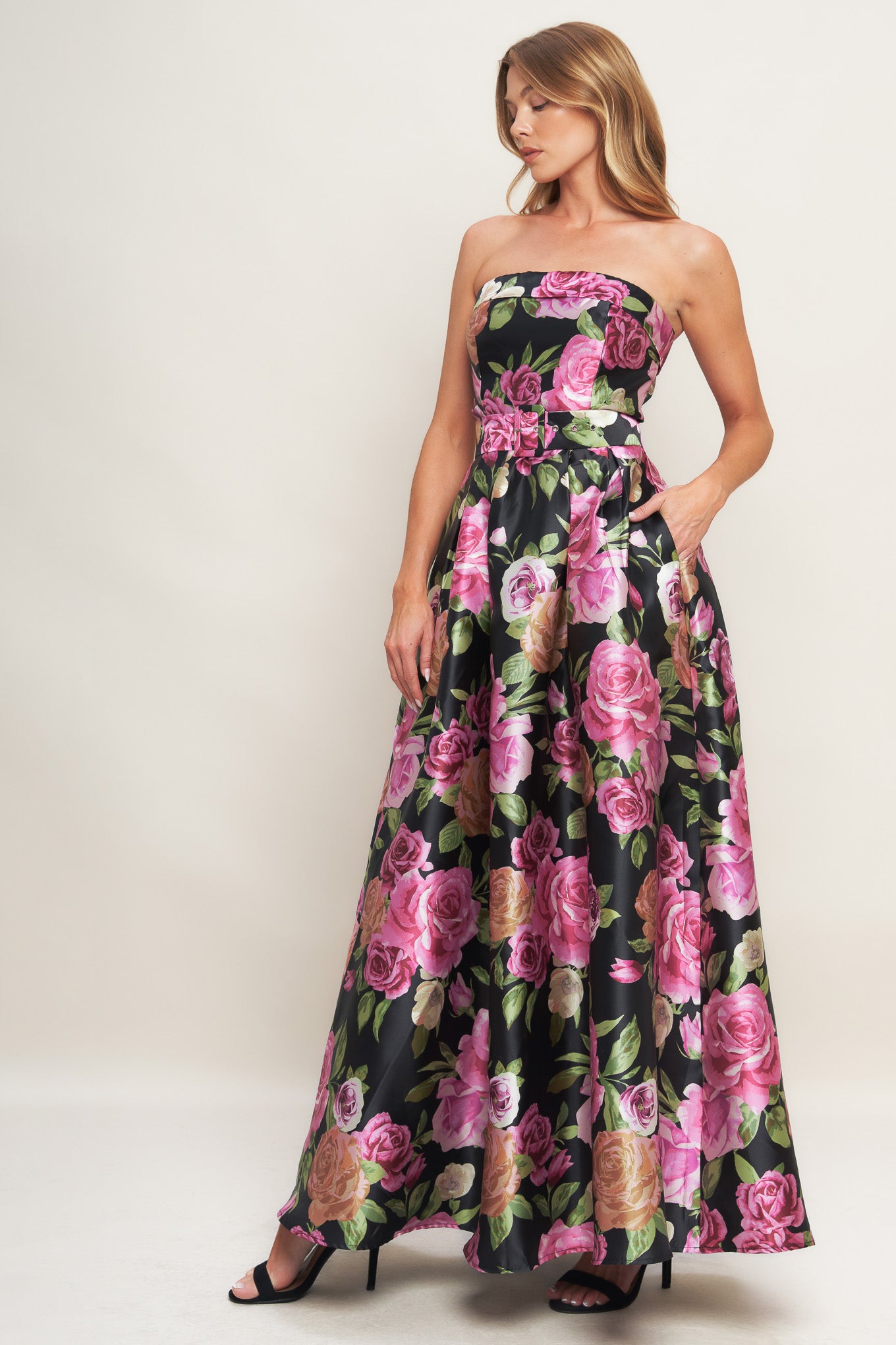 A printed woven maxi dress featuring strapless neckline, self belt, full skirt and back zipper closure