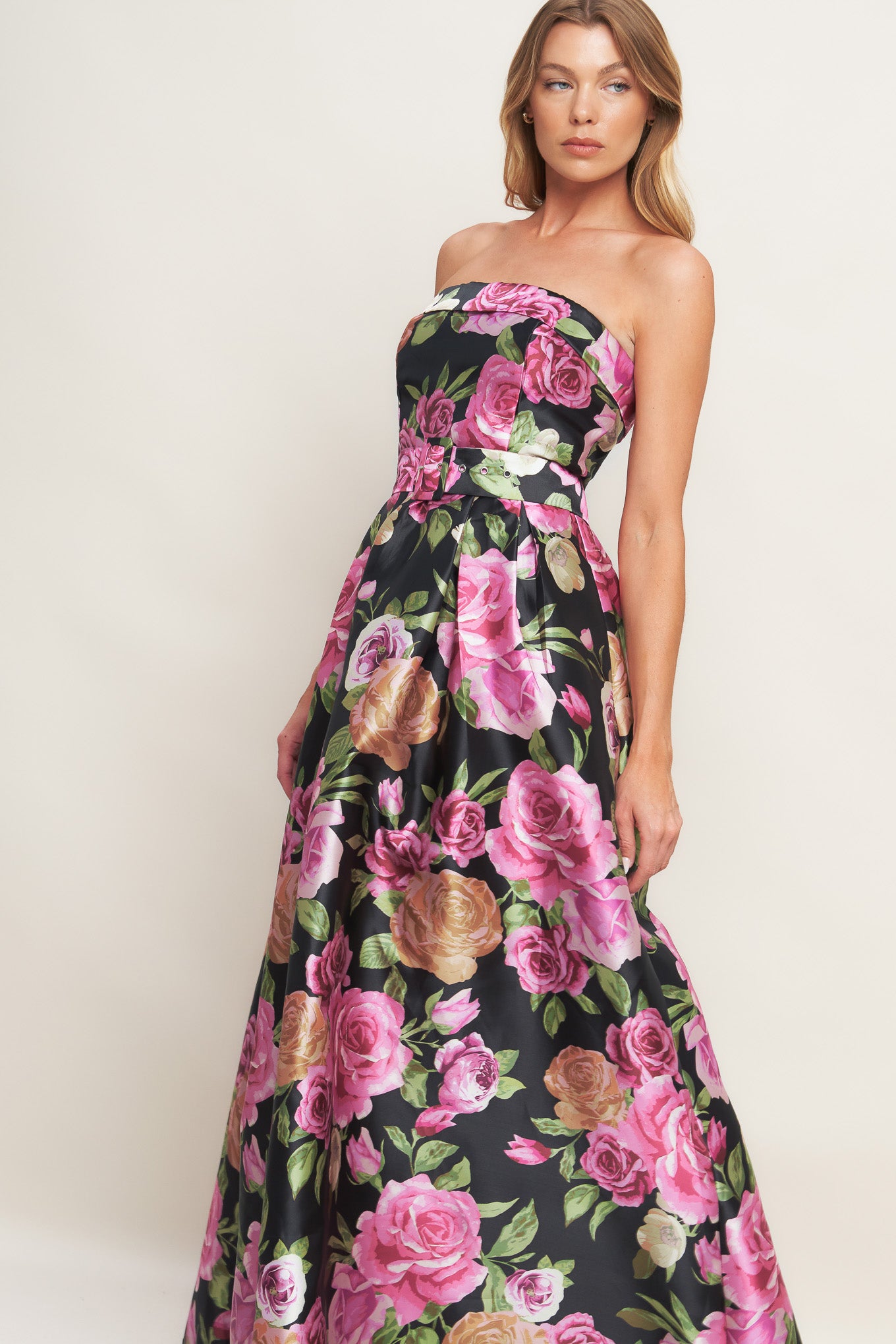 A printed woven maxi dress featuring strapless neckline, self belt, full skirt and back zipper closure