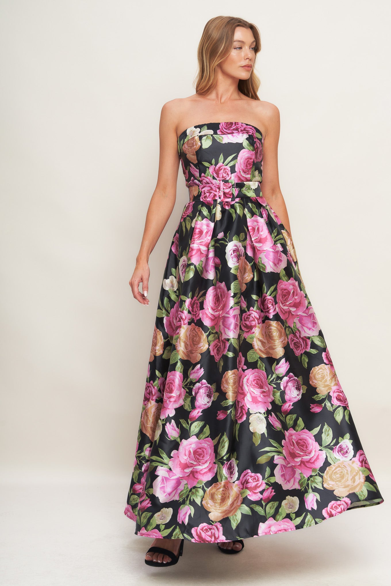 A printed woven maxi dress featuring strapless neckline, self belt, full skirt and back zipper closure