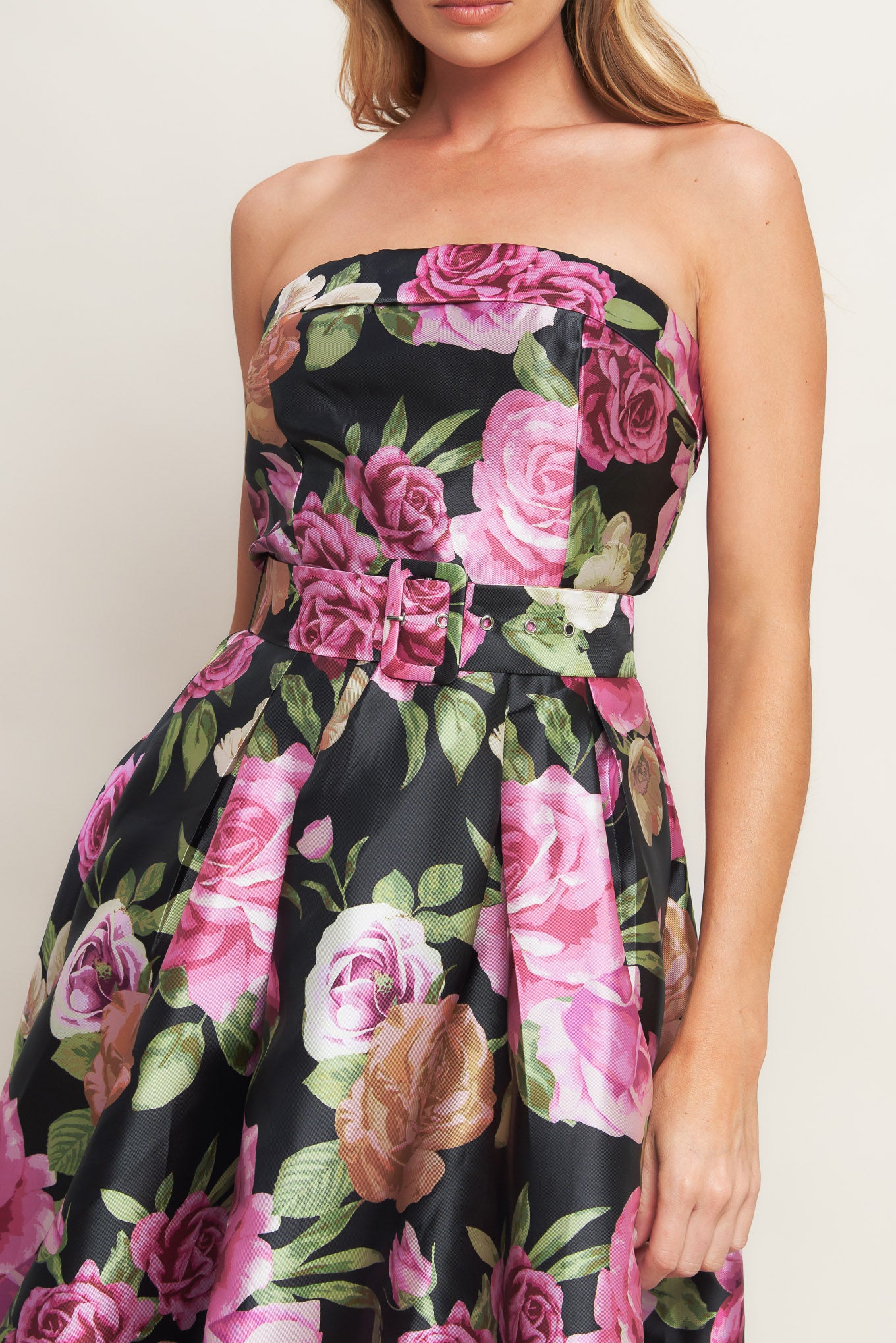 A printed woven maxi dress featuring strapless neckline, self belt, full skirt and back zipper closure