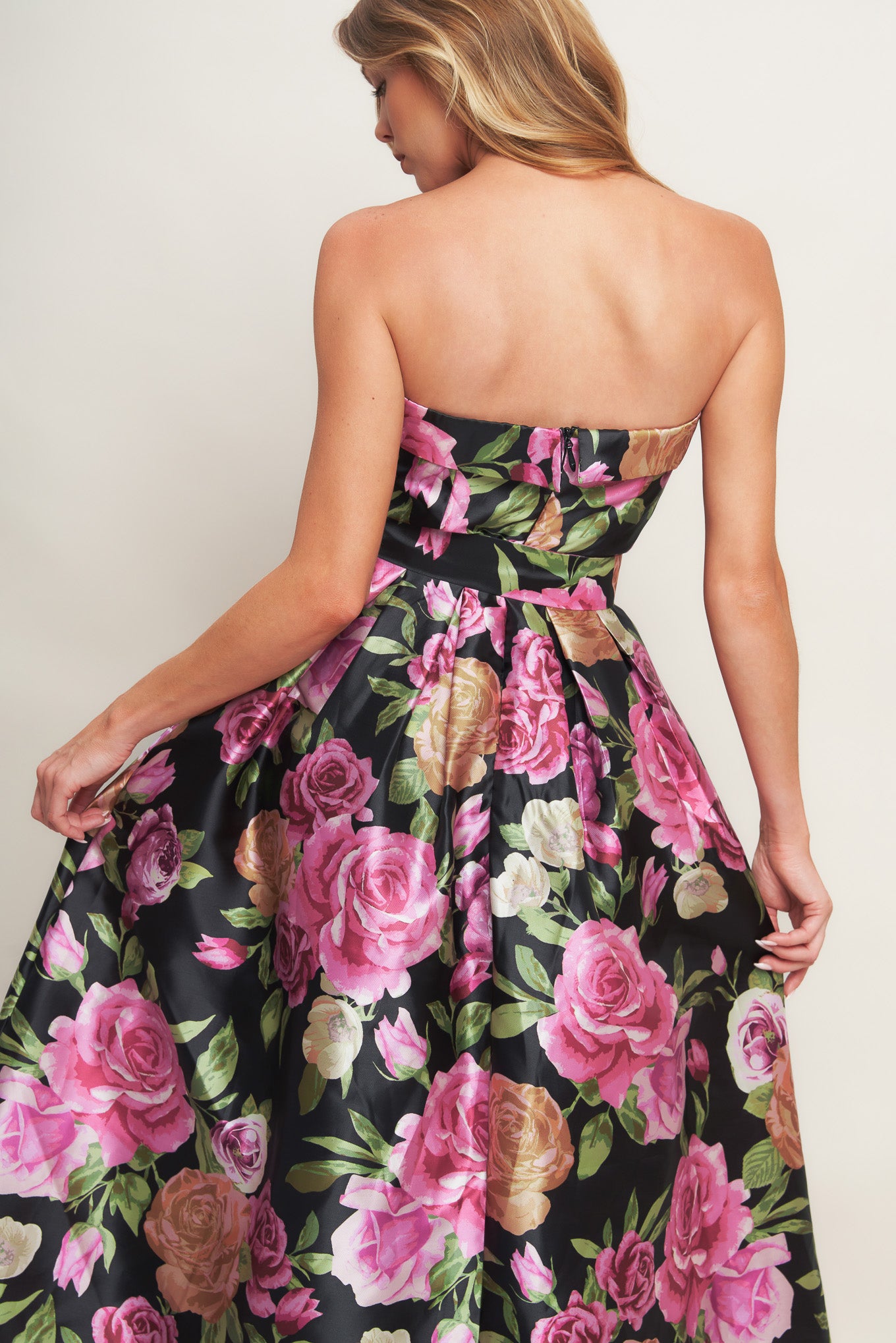 A printed woven maxi dress featuring strapless neckline, self belt, full skirt and back zipper closure