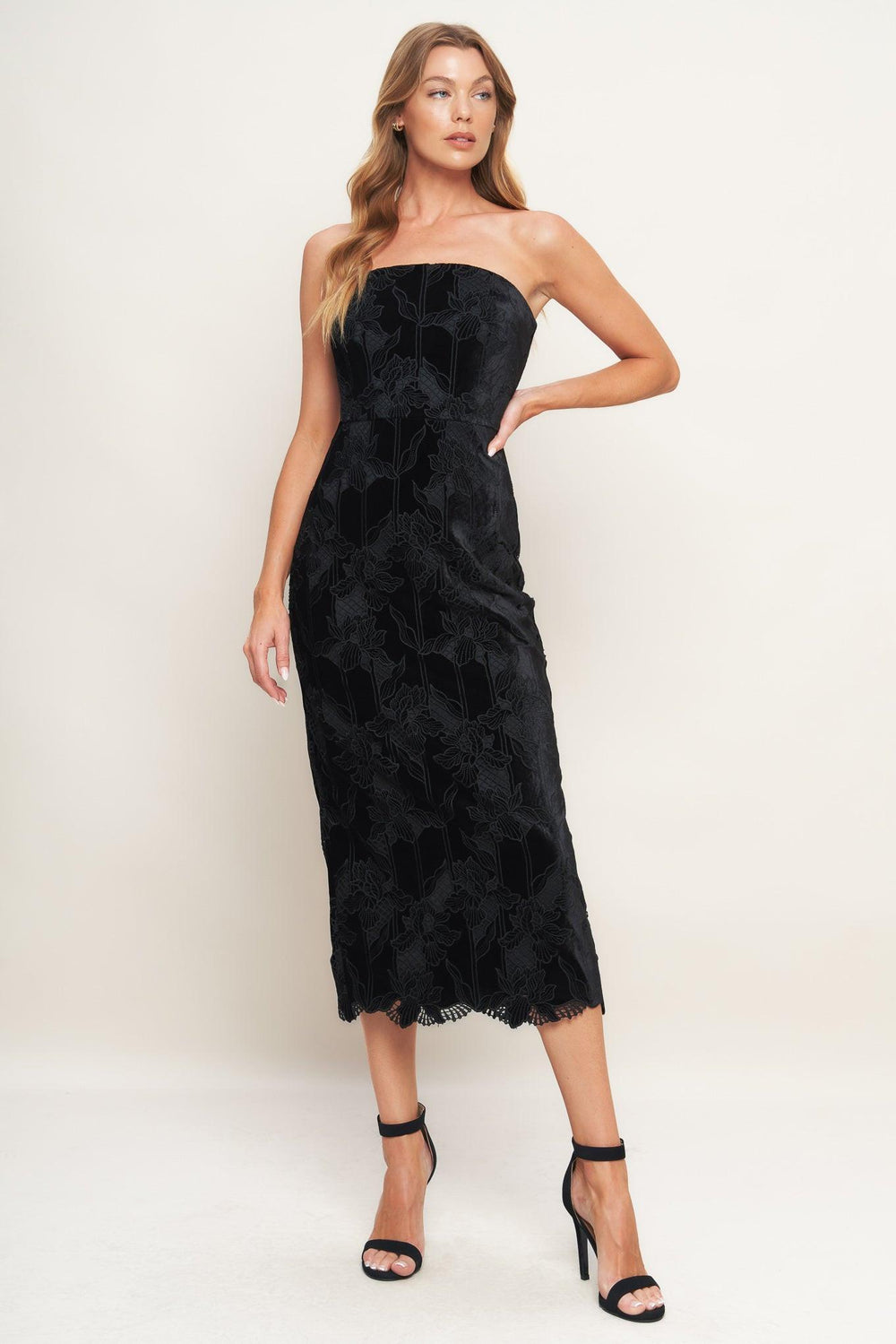 A woven velvet lace midi dress featuring strapless neckline and back zipper closure with slit