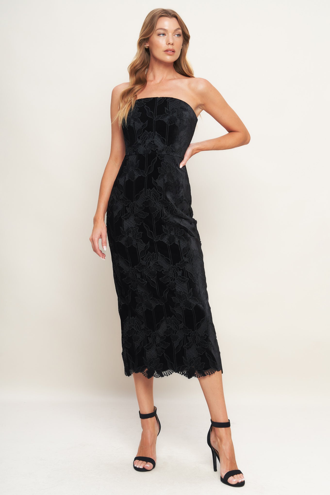 A woven velvet lace midi dress featuring strapless neckline and back zipper closure with slit