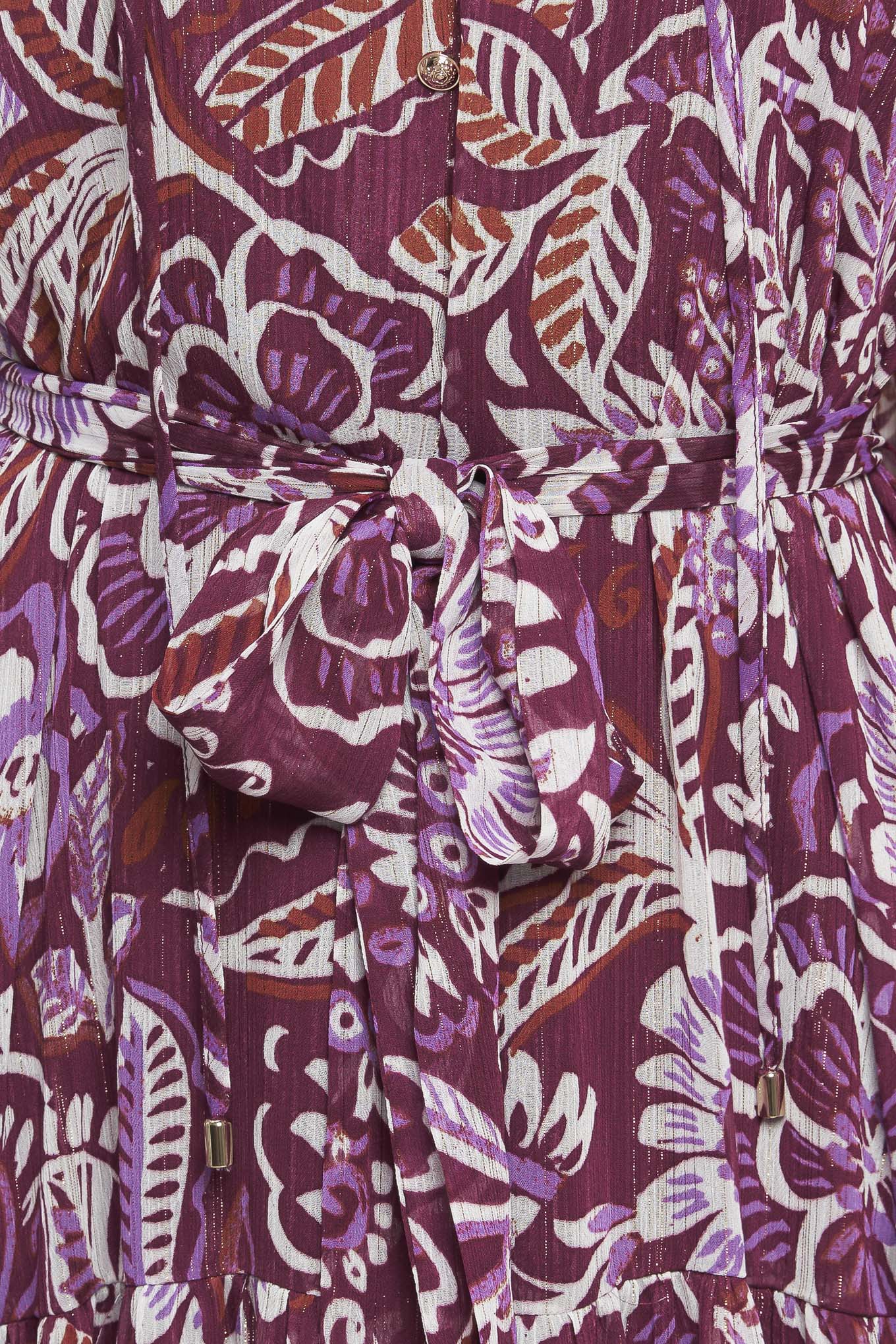 A printed woven maxi dress featuring ruffled neckline with front tie, long sleeve with ruffled cuff, tiered skirt and self sash tie