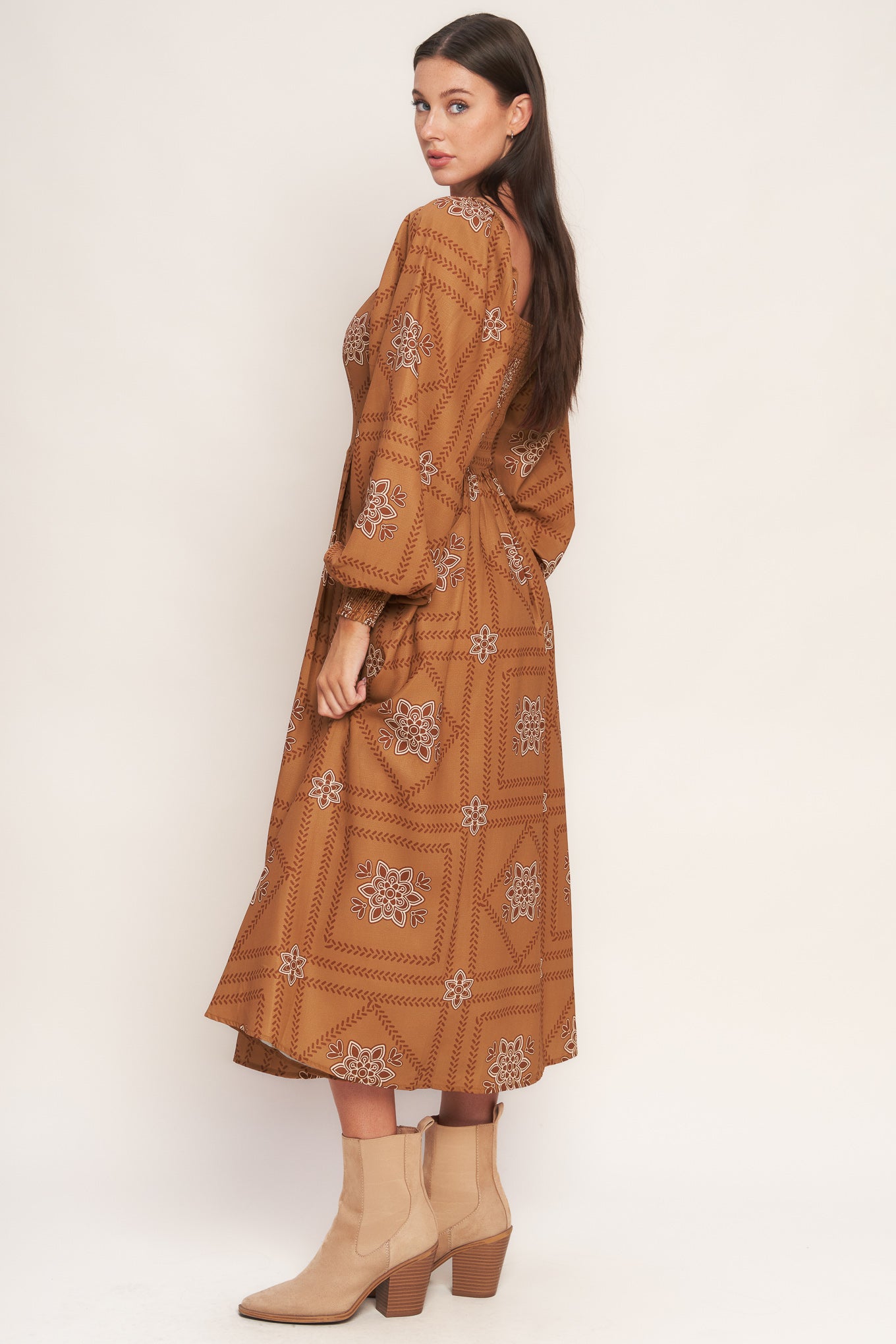 A printed woven midi dress featuring square neckline, long sleeve with smocked cuff, full skirt and smocked back bodice