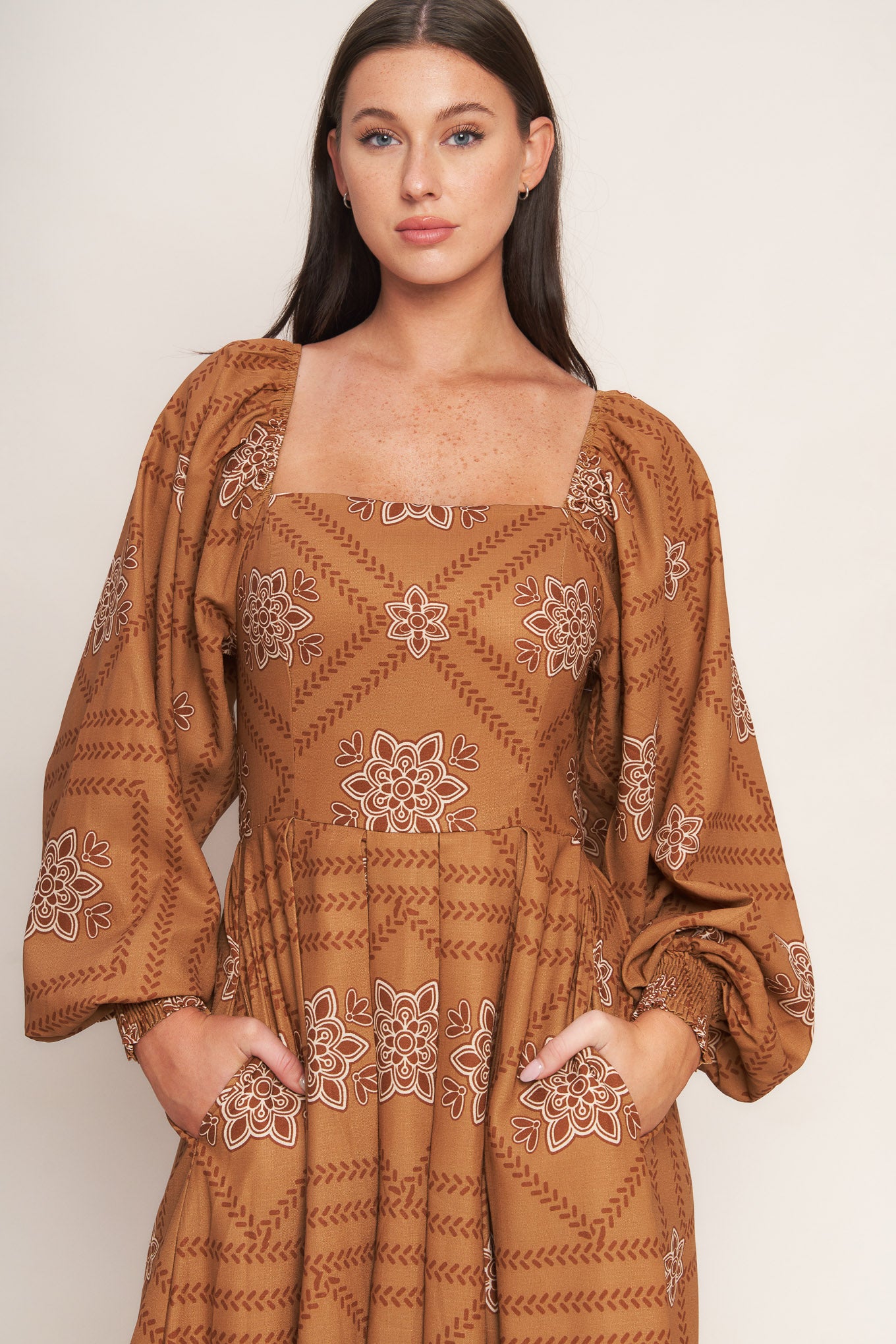A printed woven midi dress featuring square neckline, long sleeve with smocked cuff, full skirt and smocked back bodice