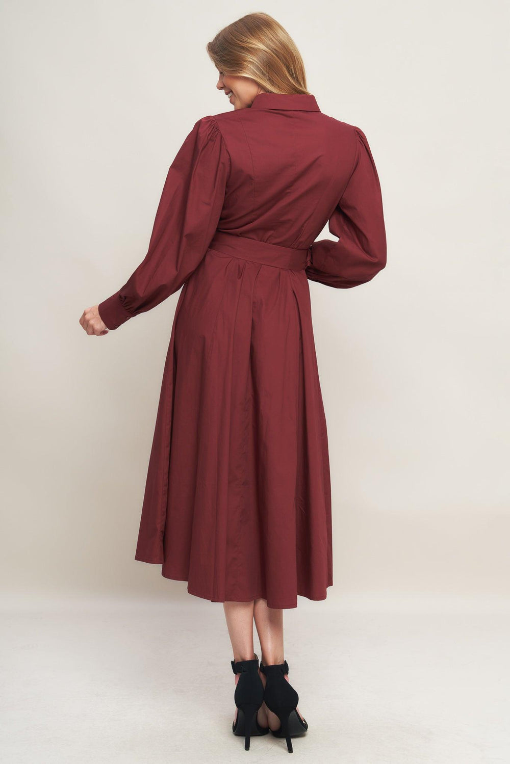 A solid woven midi dress featuring collar, button down, lace trim detail, long sleeve, self belt and full skirt