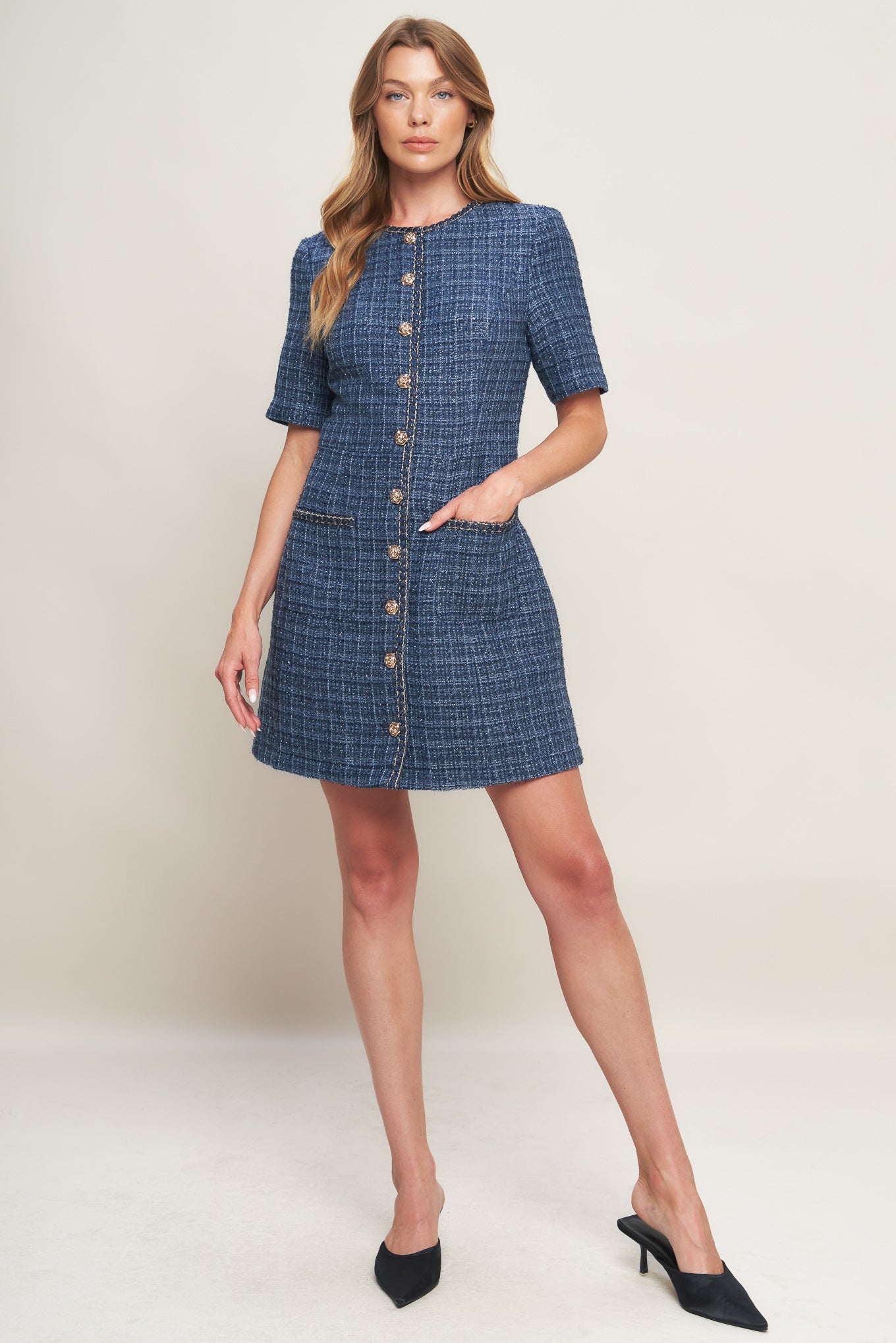 A tweed mini dress featuring round neckline, short sleeve, front button down with chain trimmed edge and pockets