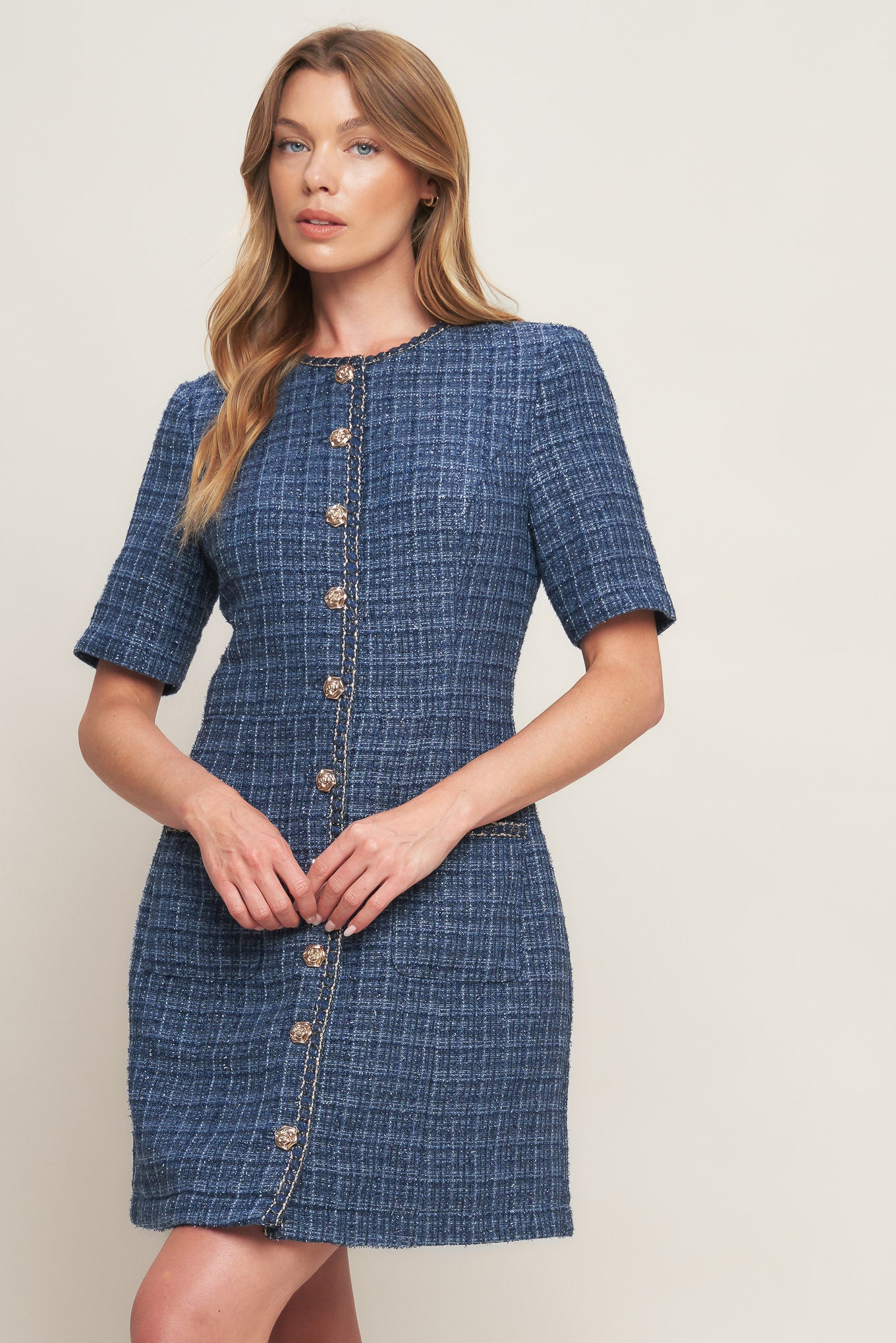 A tweed mini dress featuring round neckline, short sleeve, front button down with chain trimmed edge and pockets