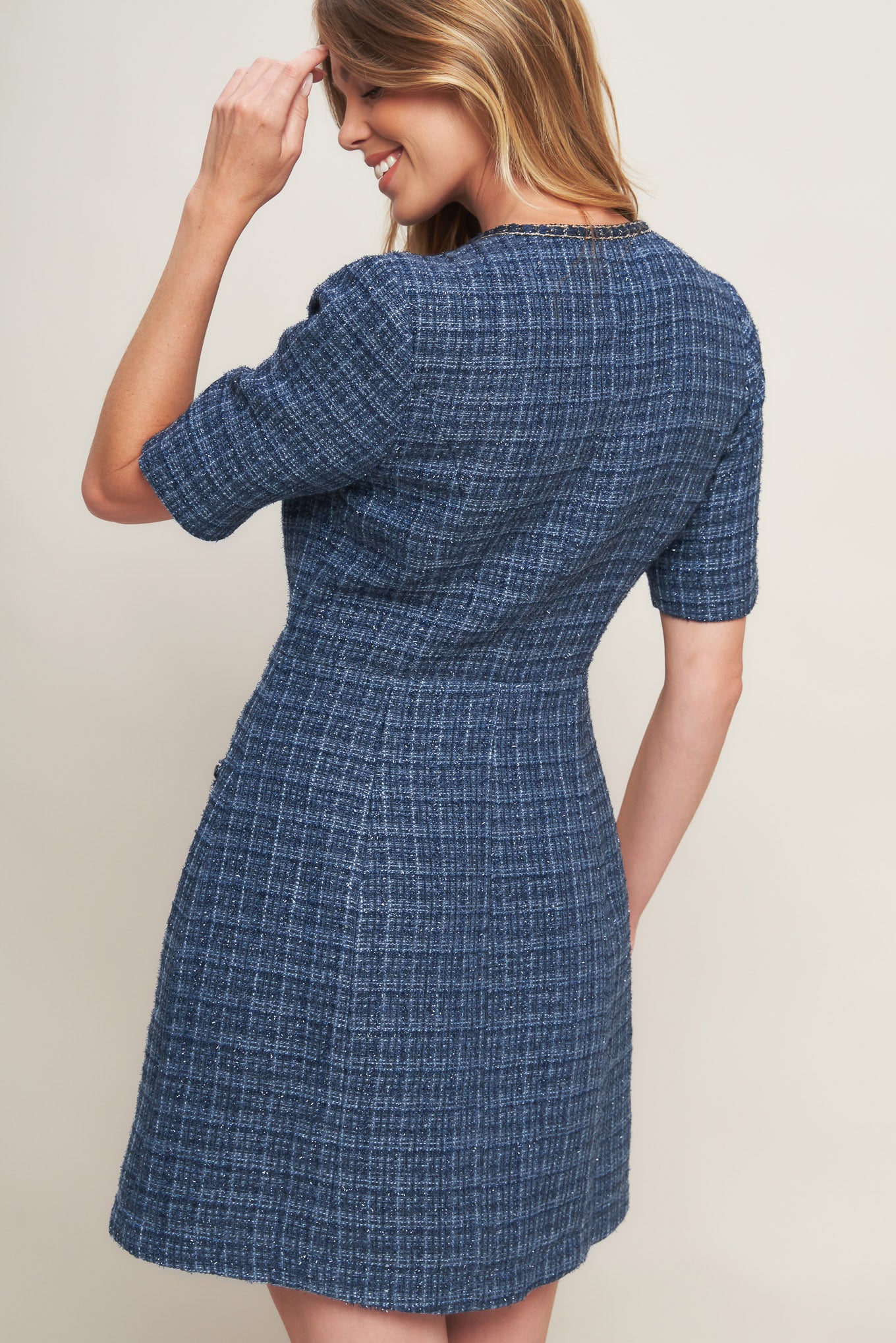 A tweed mini dress featuring round neckline, short sleeve, front button down with chain trimmed edge and pockets