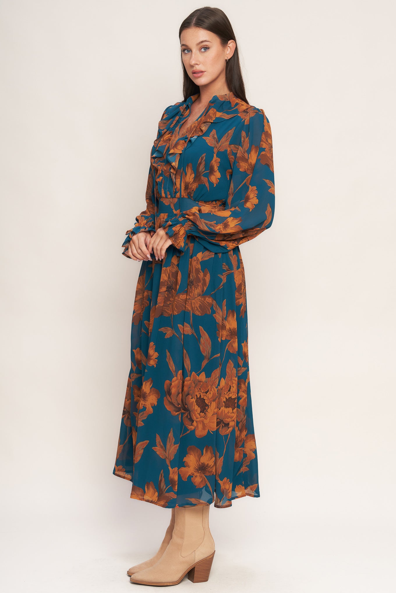 A printed woven midi dress featuring front tie/tassel with ruffles, long sleeve with ruffled cuff and elasticized waist