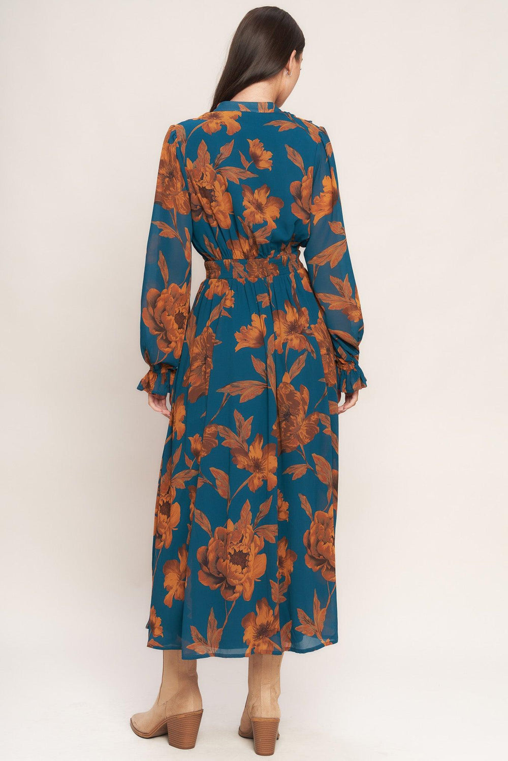 A printed woven midi dress featuring front tie/tassel with ruffles, long sleeve with ruffled cuff and elasticized waist