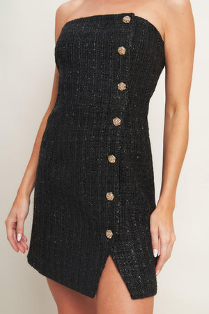 A tweed mini dress featuring strapless neckline, button down detail and back zipper closure