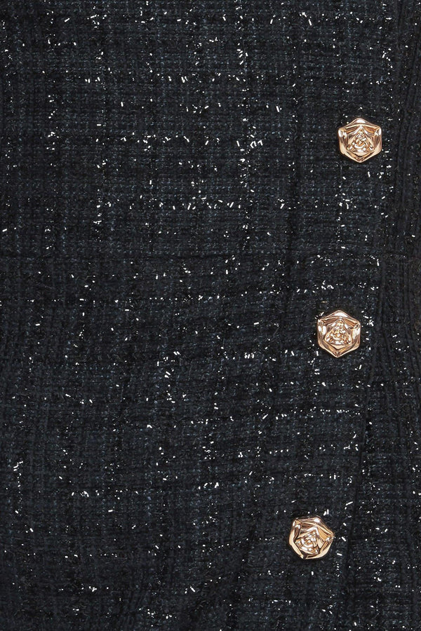 A tweed mini dress featuring strapless neckline, button down detail and back zipper closure