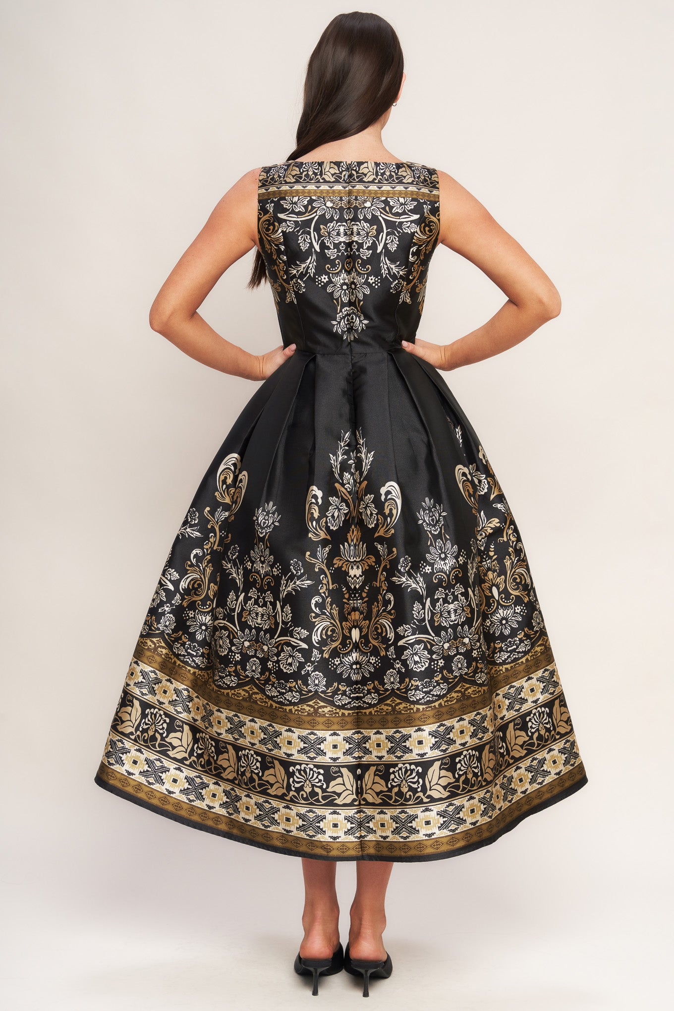 A printed woven midi dress featuring round neckline, sleeveless, full skirt and back zipper closure