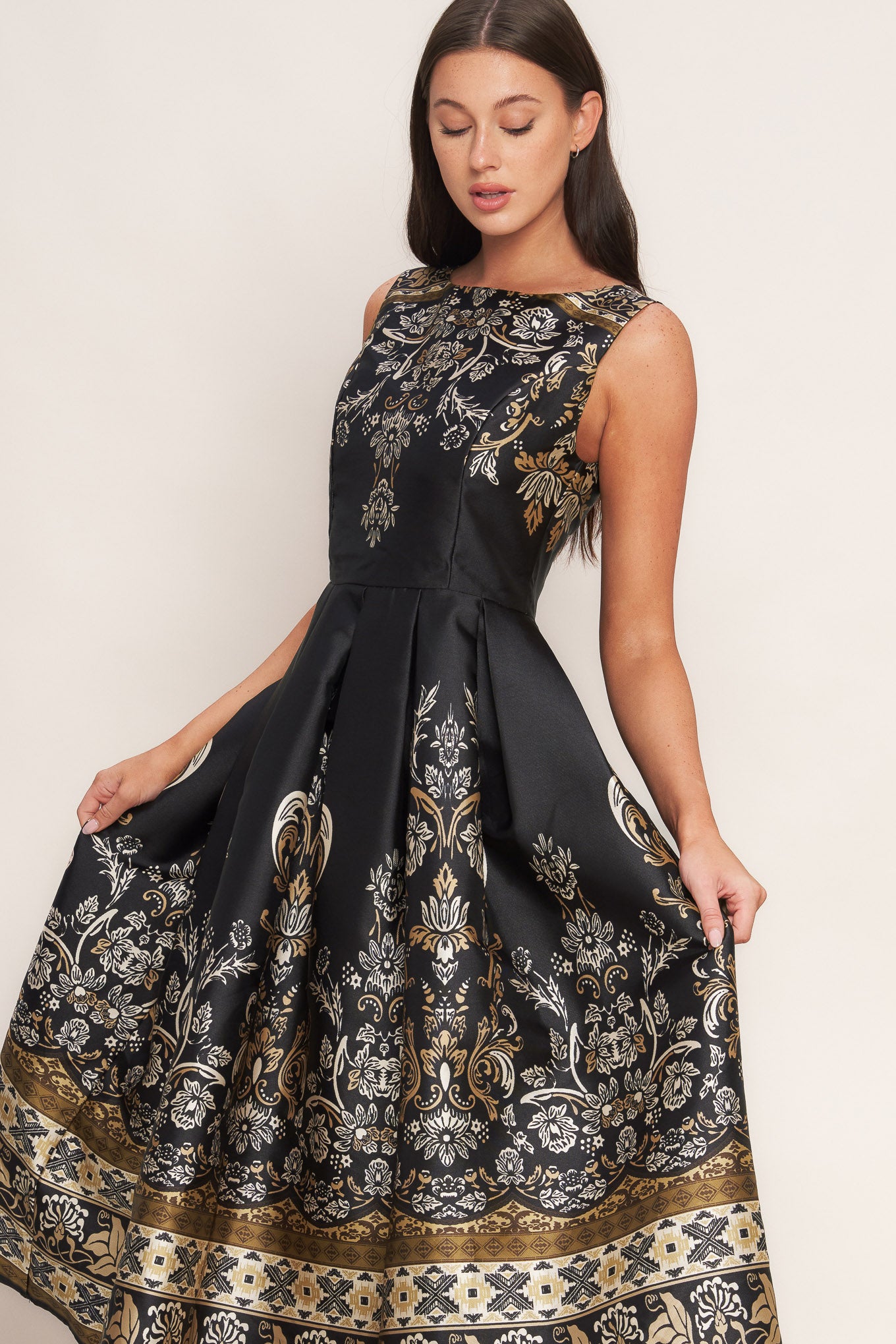 A printed woven midi dress featuring round neckline, sleeveless, full skirt and back zipper closure