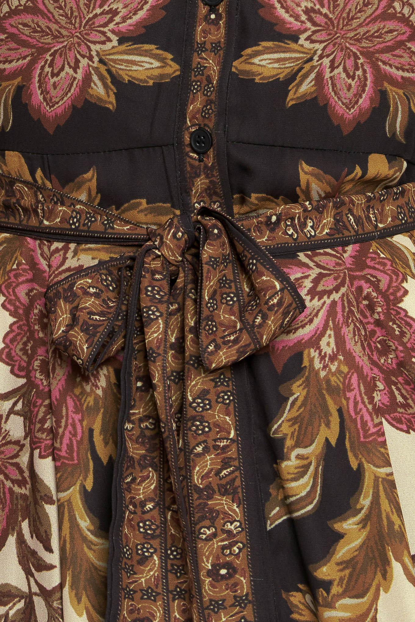 A printed woven maxi dress featuring collar, button down, long sleeve with cuff, self sash tie, and ruffled hemline