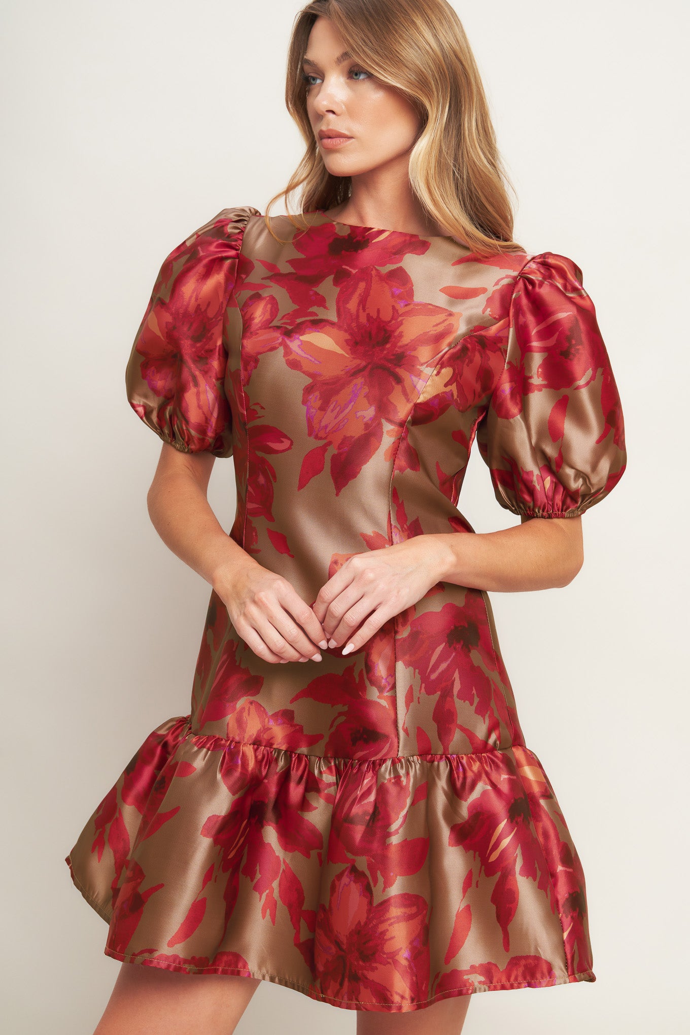 A printed woven mini dress featuring round neckline, short puff sleeve, ruffled hemline and back zipper closure
