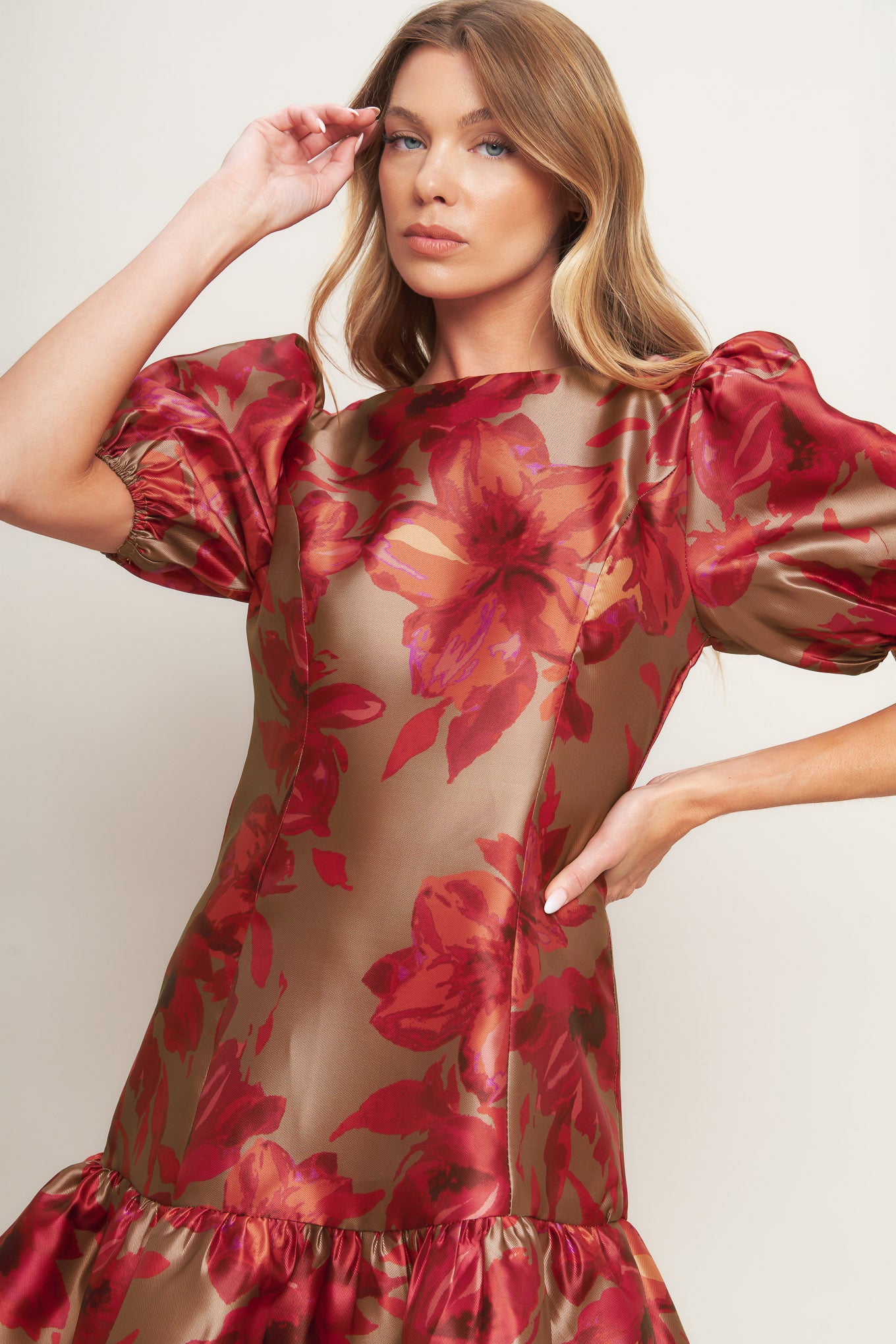 A printed woven mini dress featuring round neckline, short puff sleeve, ruffled hemline and back zipper closure