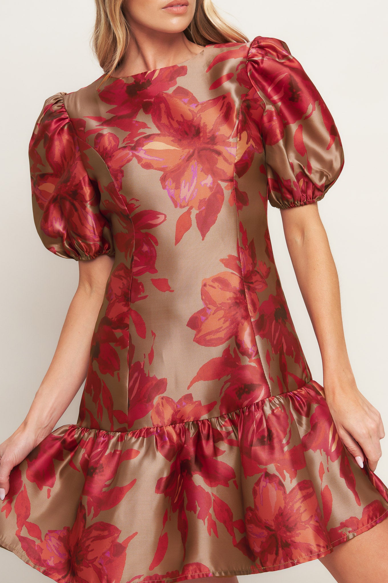 A printed woven mini dress featuring round neckline, short puff sleeve, ruffled hemline and back zipper closure