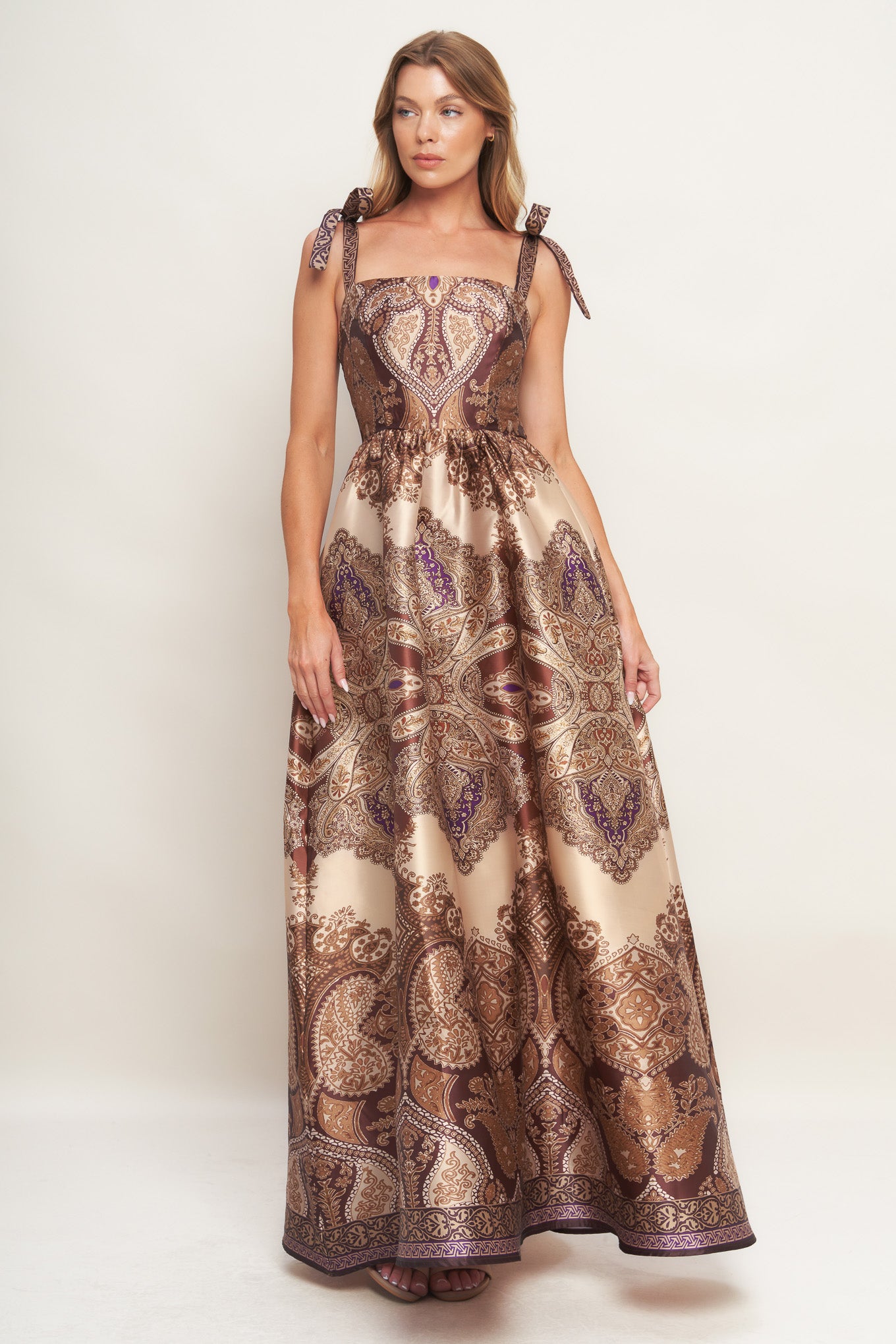 A printed woven maxi dress featuring straight neckline, shoulder tie, full skirt and smocked back bodice