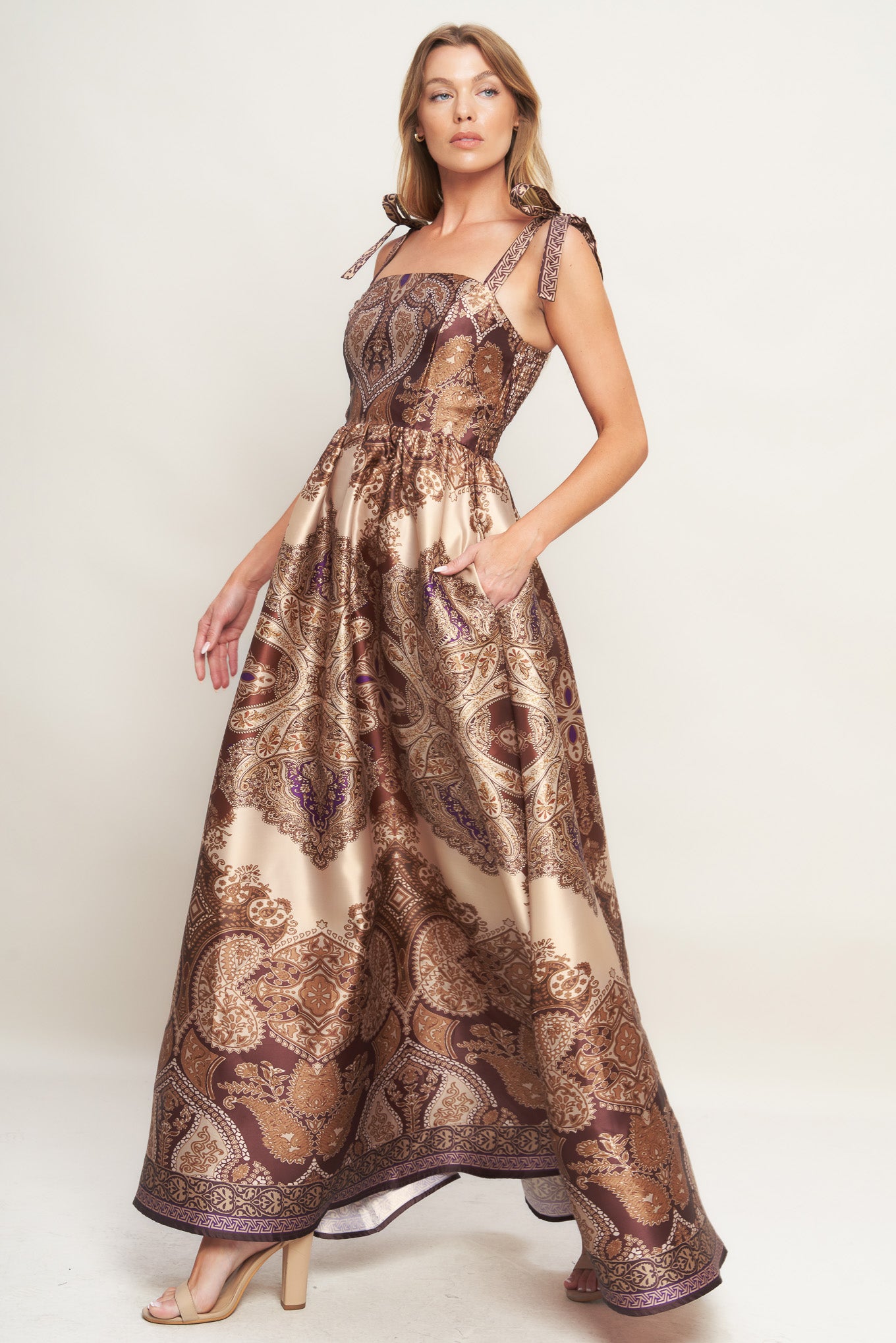 A printed woven maxi dress featuring straight neckline, shoulder tie, full skirt and smocked back bodice
