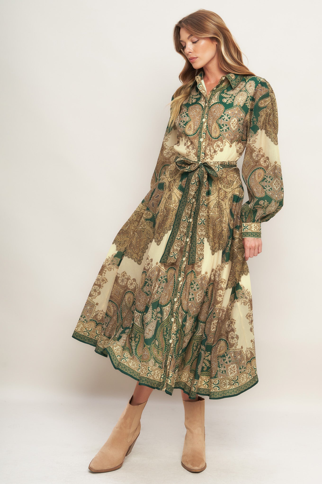 A printed woven midi dress featuring collar, front button down closure, long sleeve with cuff and circle skirt