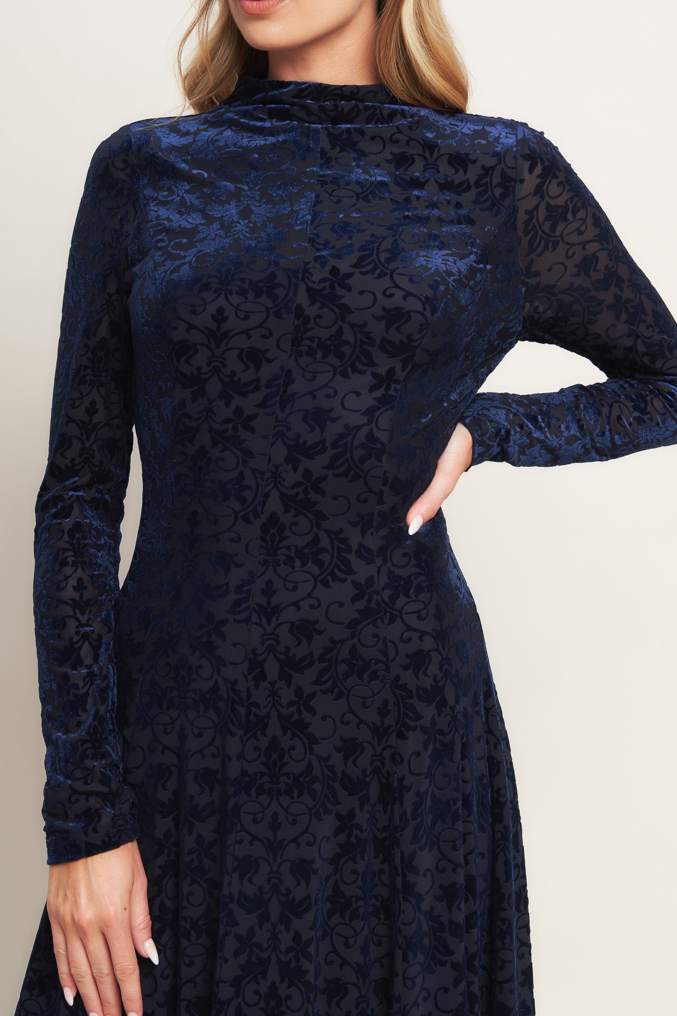 A knit burn out velvet midi dress featuring tubular neckline, long sleeve, circle skirt and back zipper closure