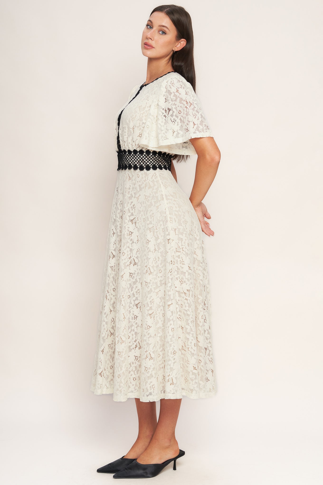 A solid woven lace midi dress featuring round neckline, lace inset detail, circle skirt and back zipper closure