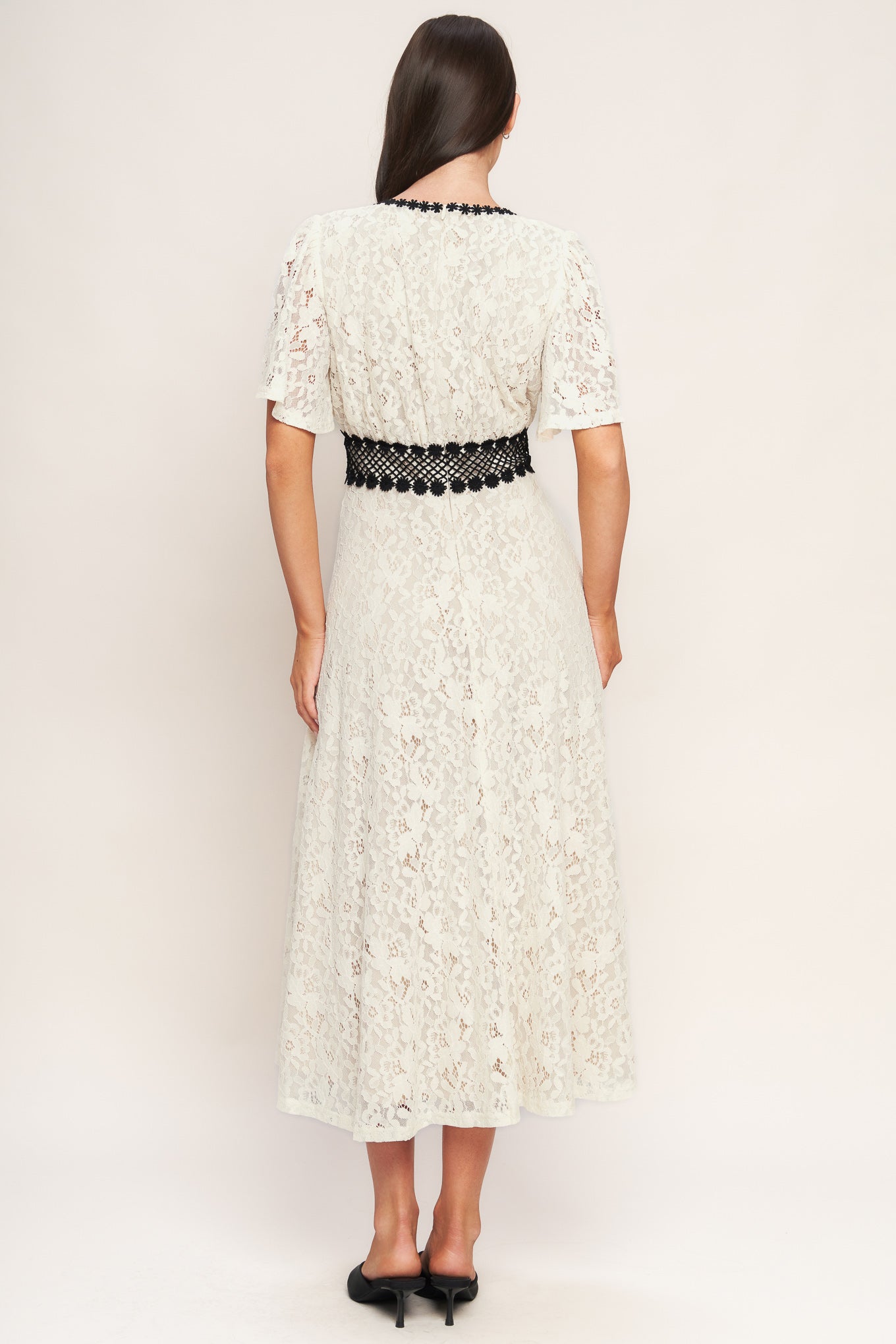 A solid woven lace midi dress featuring round neckline, lace inset detail, circle skirt and back zipper closure