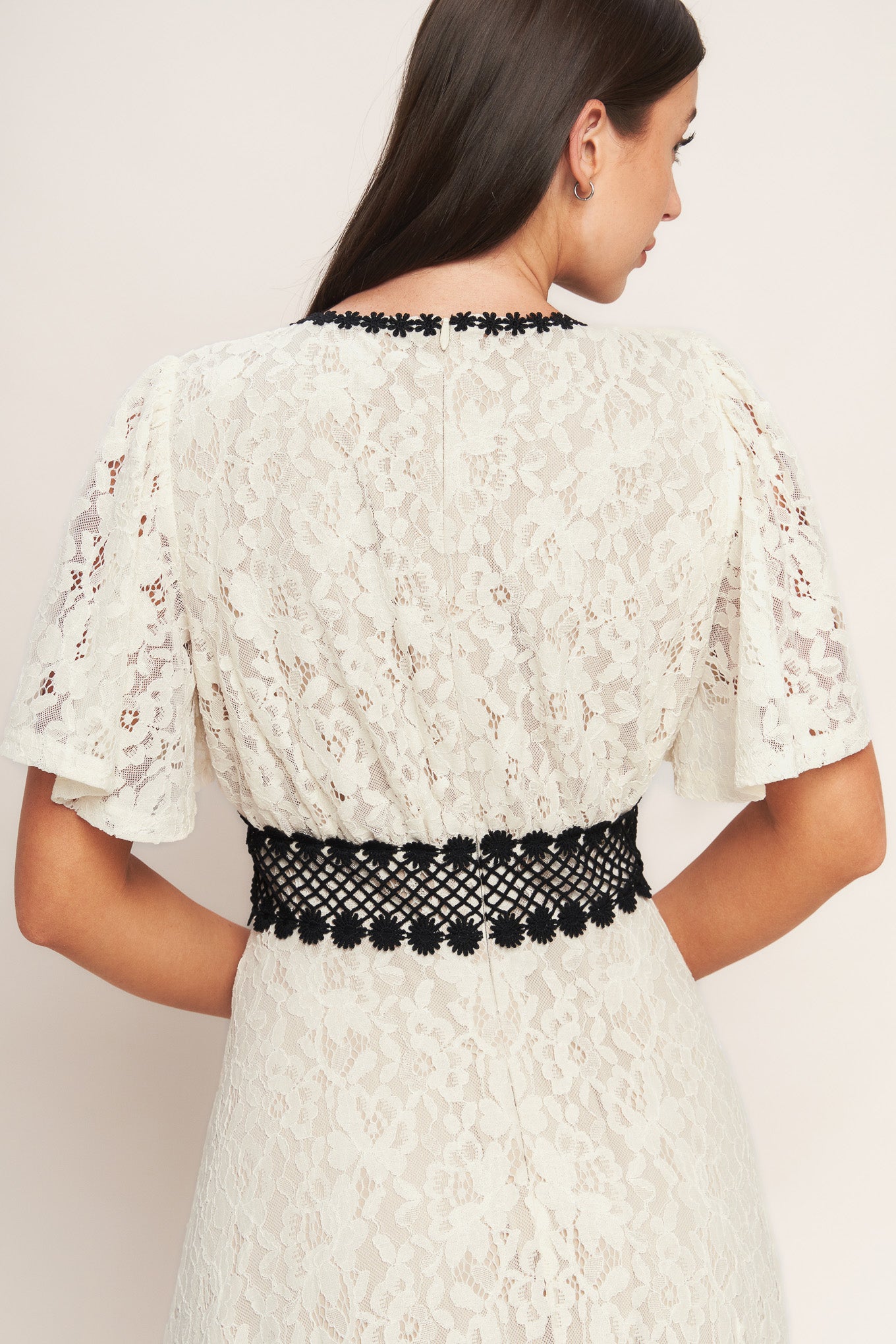 A solid woven lace midi dress featuring round neckline, lace inset detail, circle skirt and back zipper closure