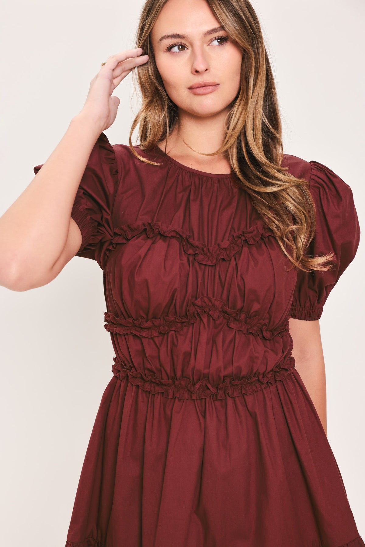 Woman wearing a maroon short puff sleeve mini dress | Flying Tomato
