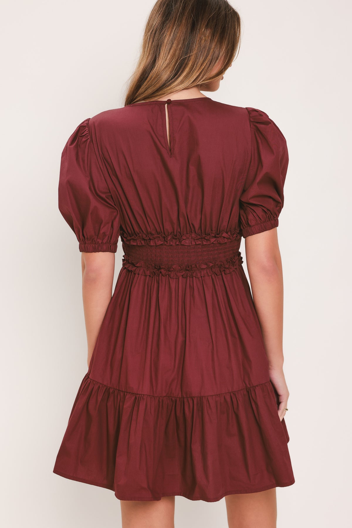 Woman wearing a maroon short puff sleeve mini dress | Flying Tomato