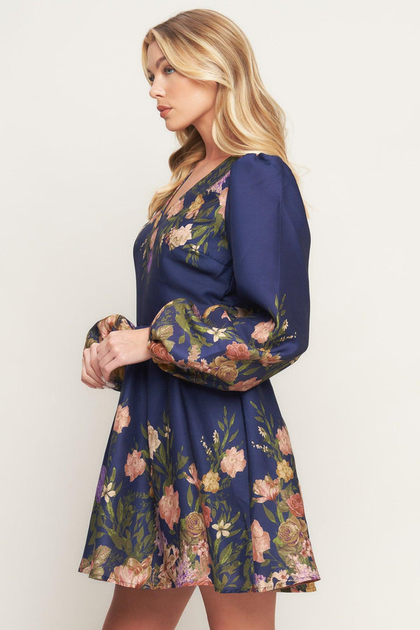 A printed woven mini dress featuring V neckline, long sleeve, full skirt and back zipper closure