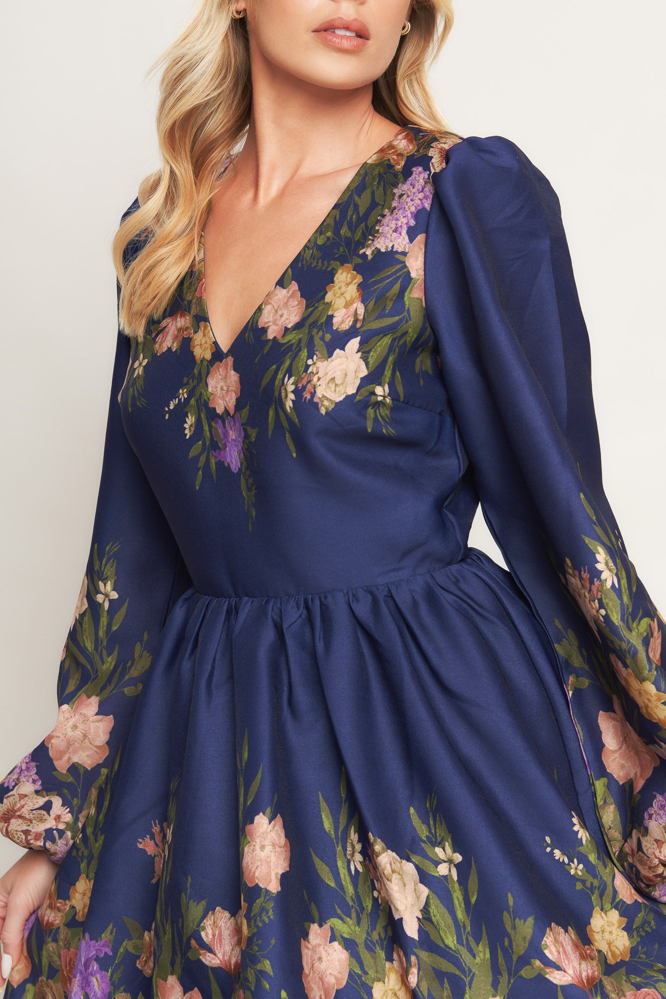 A printed woven mini dress featuring V neckline, long sleeve, full skirt and back zipper closure