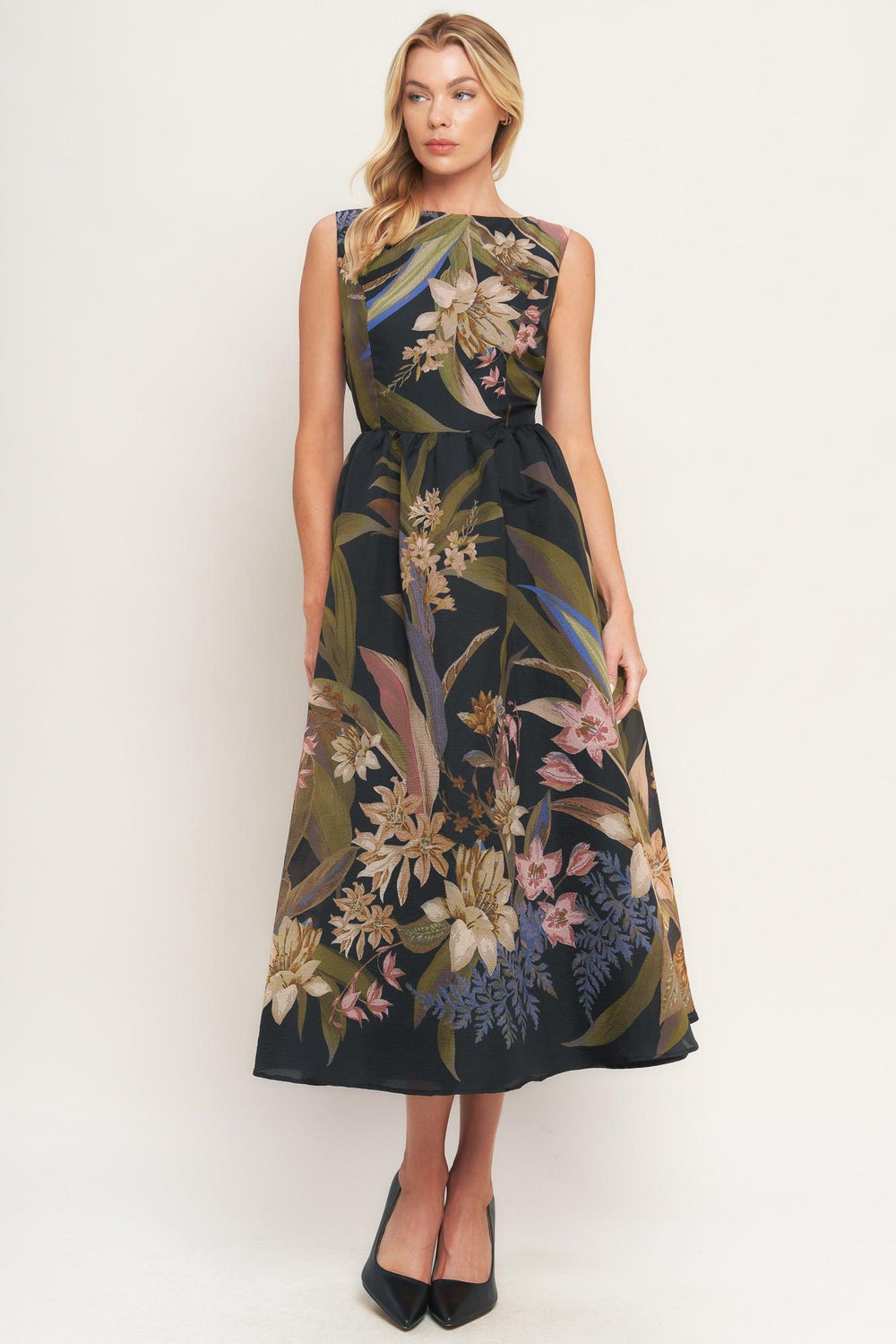 Woman wearing a black midi dress with floral and leaf print | Flying Tomato 