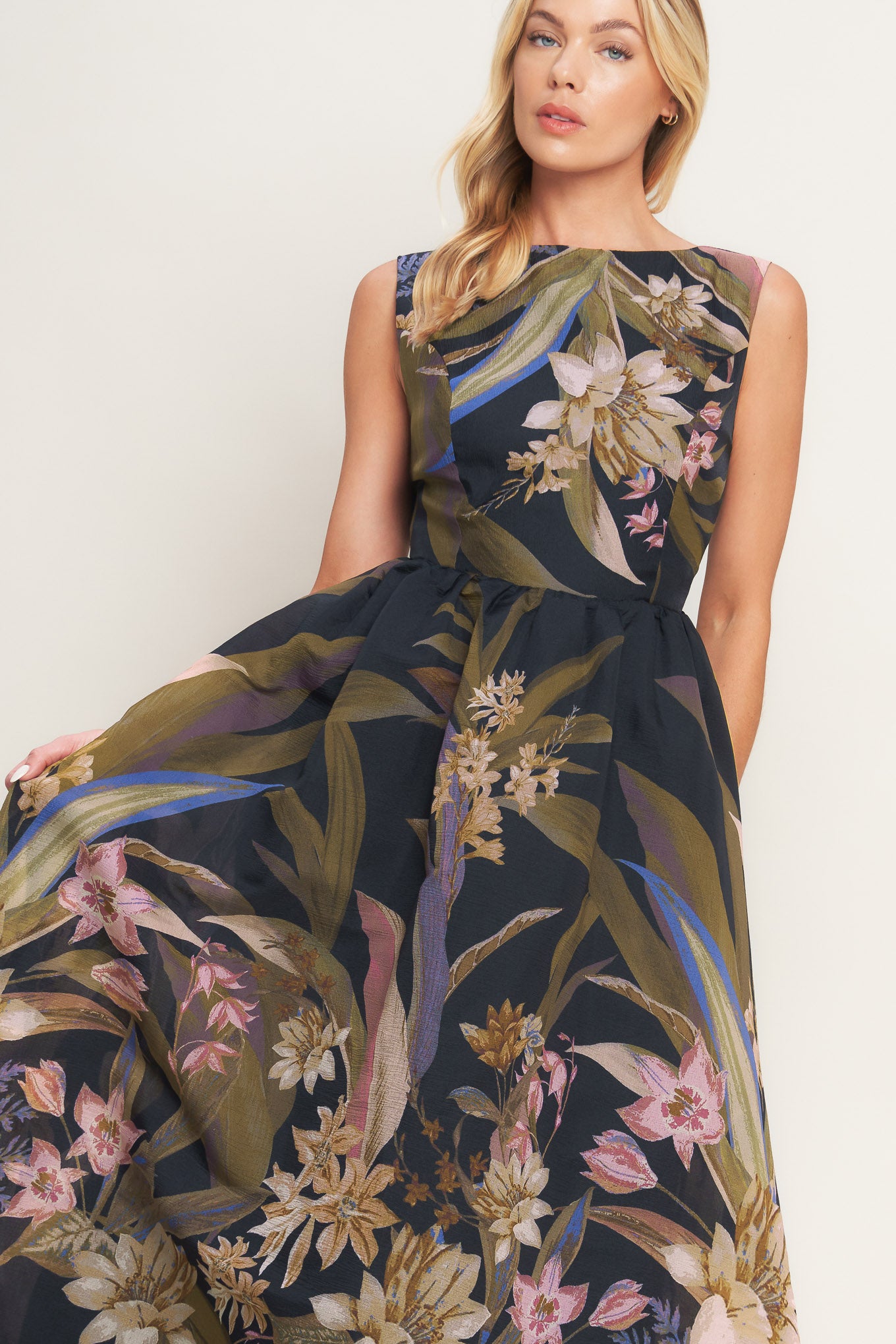 A printed woven midi dress featuring wide neckline, sleeveless, full skirt and back zipper closure