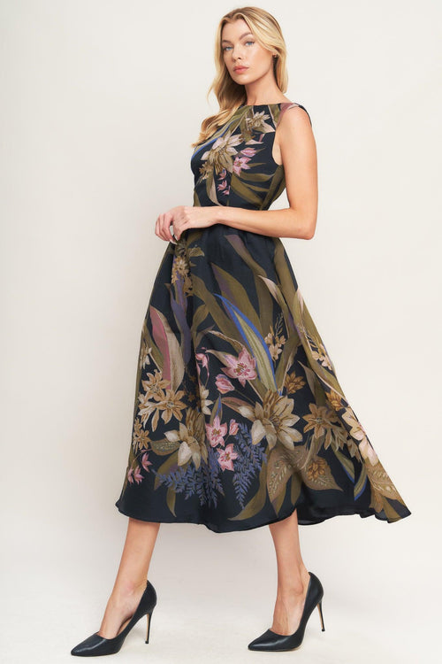 Woman wearing a black midi dress with floral and leaf print | Flying Tomato 