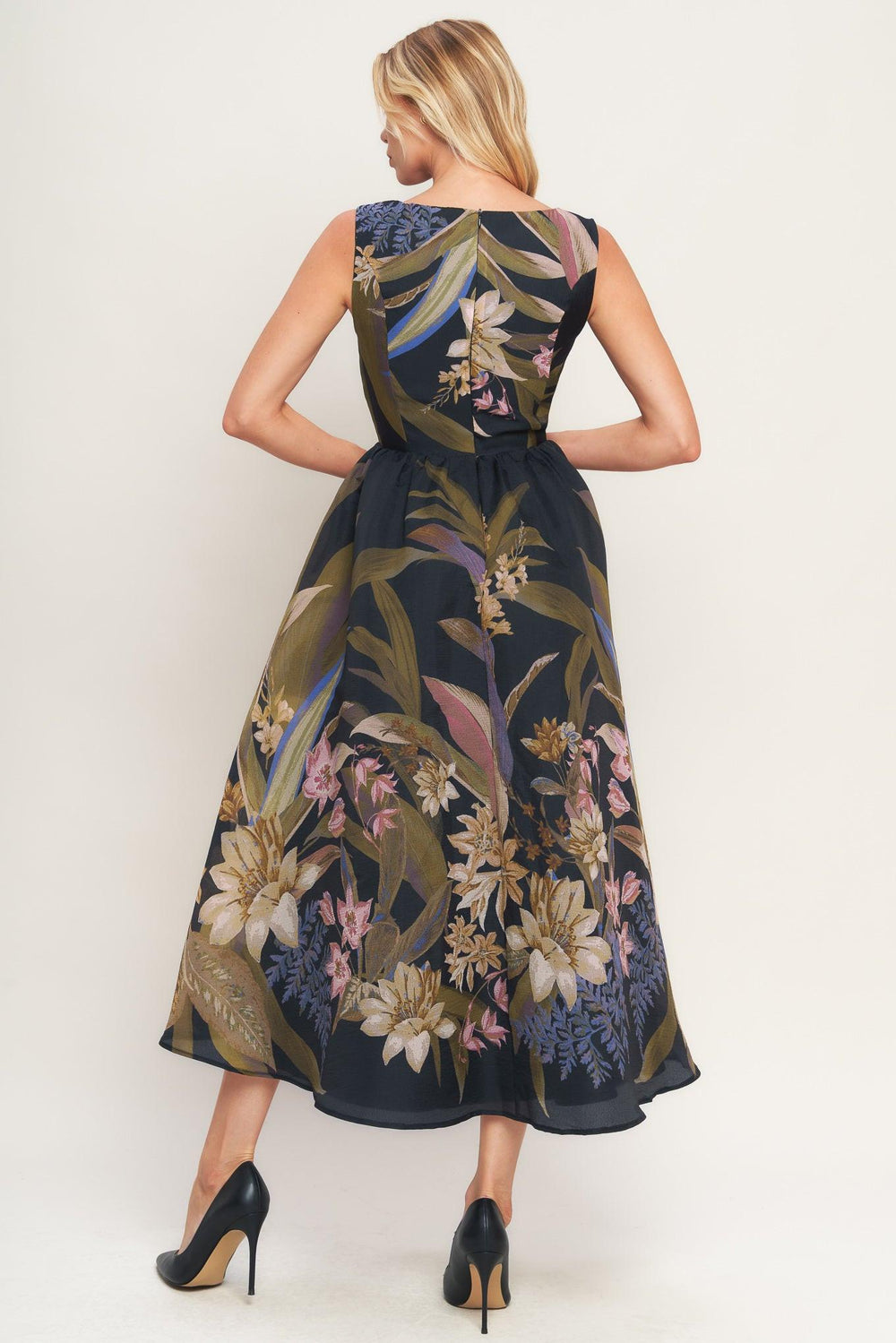 Woman wearing a black midi dress with floral and leaf print | Flying Tomato 