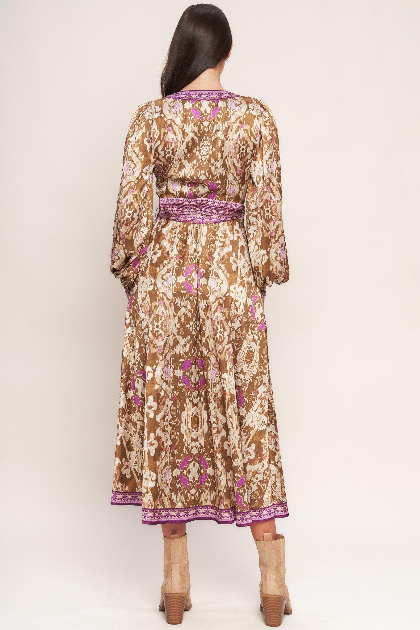 A printed woven midi true wrap dress featuring surplice neckline and long sleeve with smocked cuff