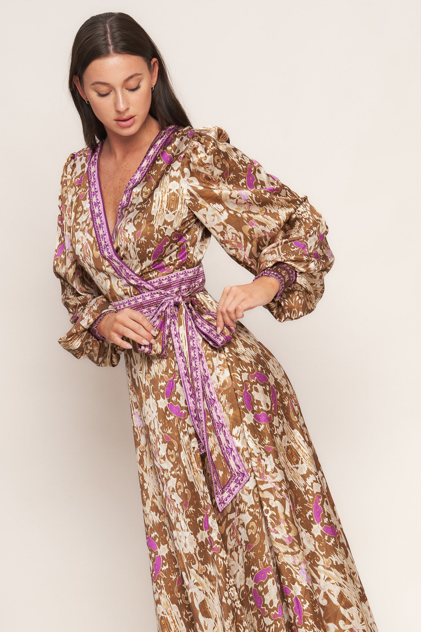A printed woven midi true wrap dress featuring surplice neckline and long sleeve with smocked cuff